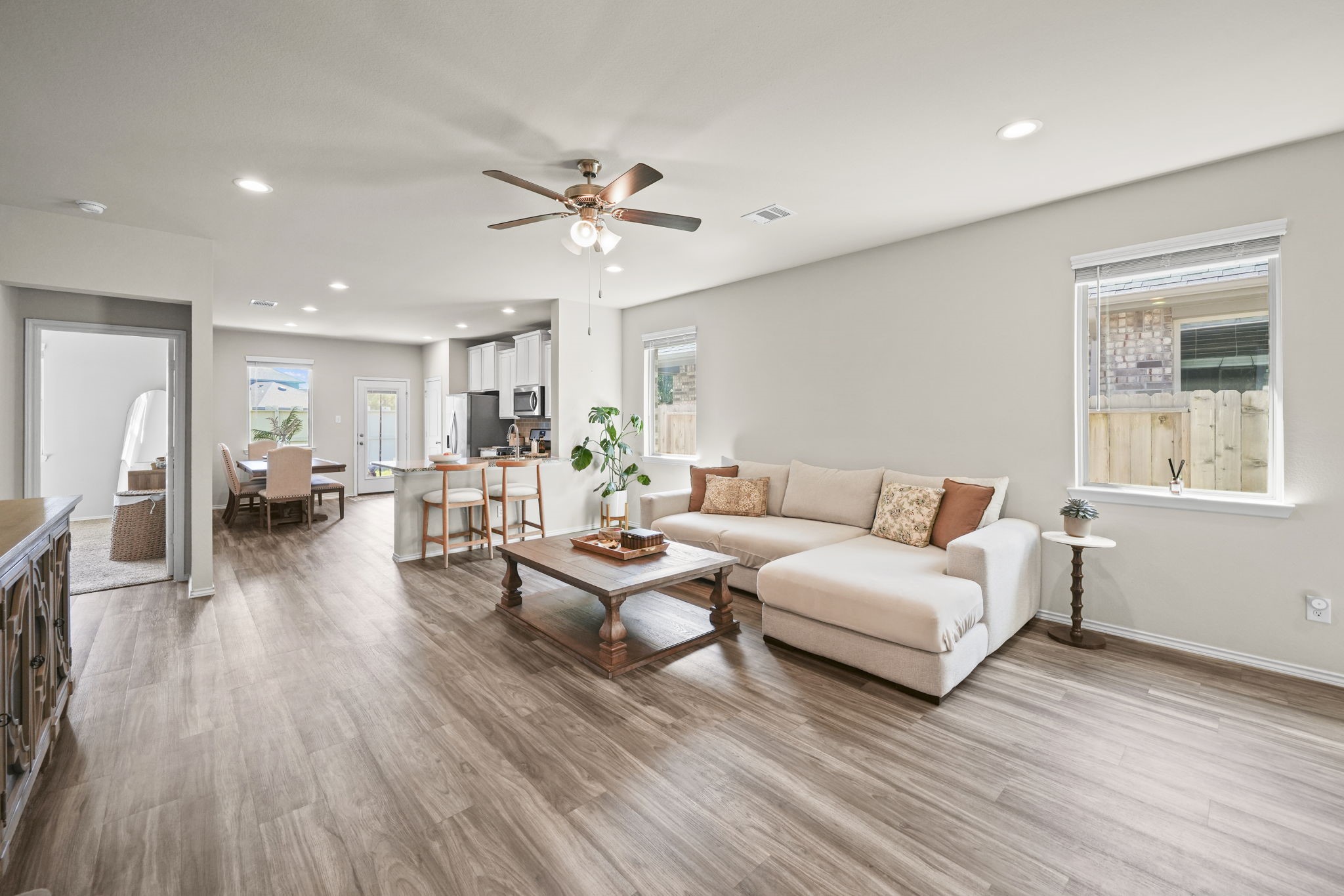Inviting living room with natural light, warm wood-look flooring, and an open layout perfect for everyday living and entertaining.
