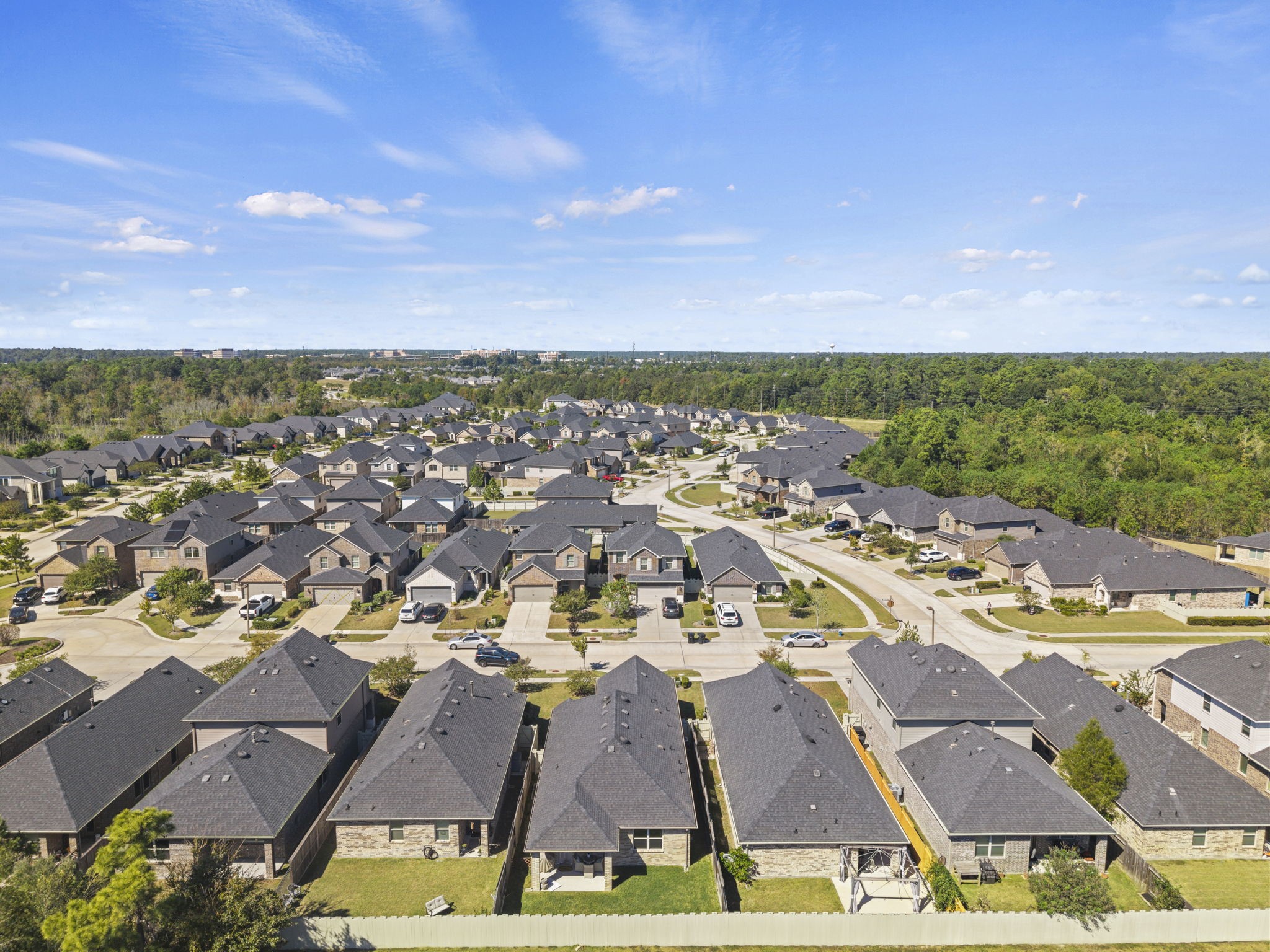 An aerial view highlighting the spacious backyard, covered patio, and outdoor space ready for relaxation and entertaining.