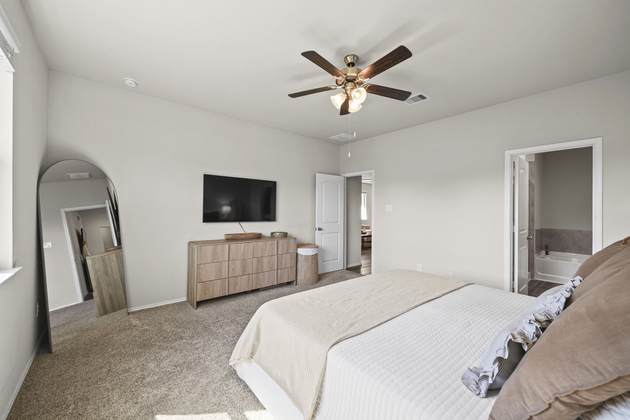 A peaceful space to call your own, this primary bedroom offers a warm and comfortable setting to start and end each day.