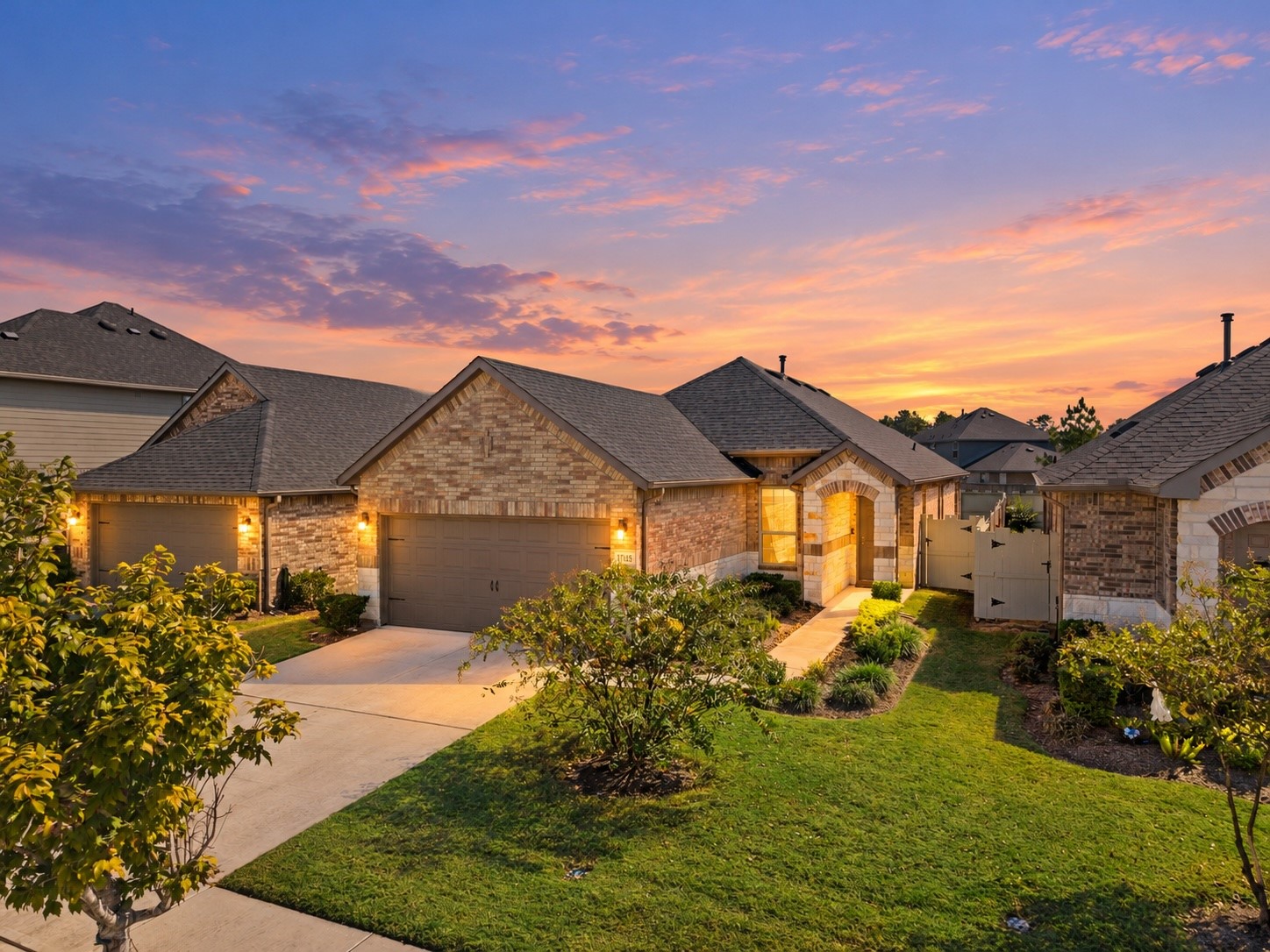 Charming single-story brick home featuring a welcoming covered entry, a two-car garage, and a landscaped front yard with a spacious driveway.

Virtually Enhanced