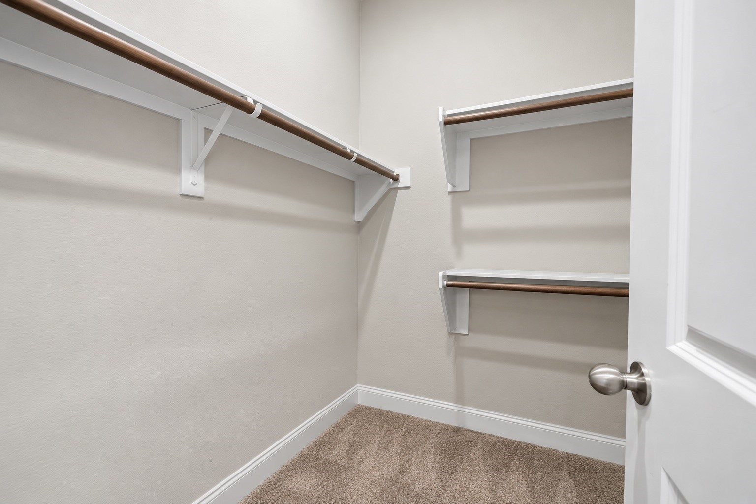 Spacious walk-in closet with built-in shelving and hanging space to keep your wardrobe organized and easily accessible.

Virtually Enhanced