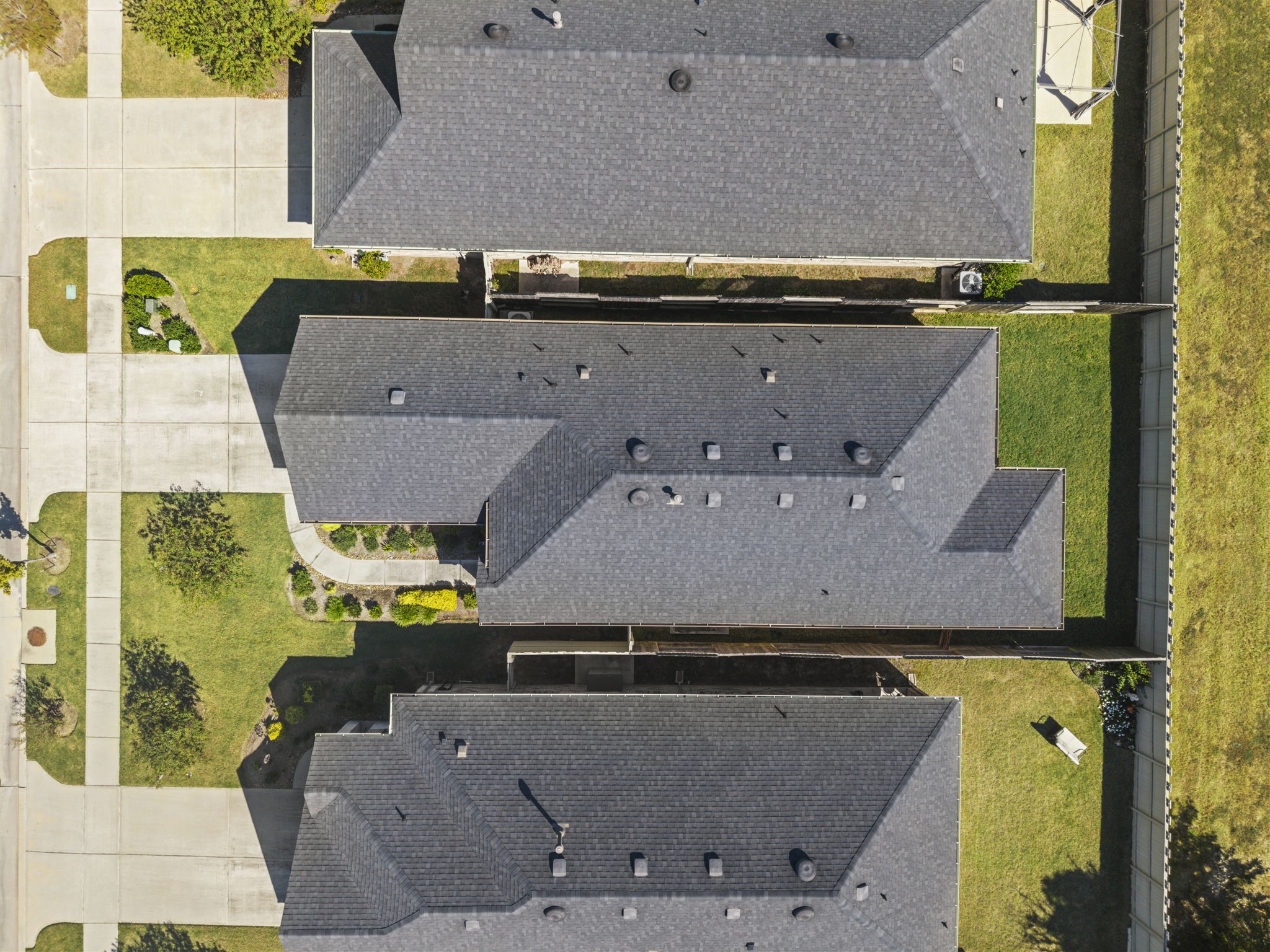 A birds-eye view showcasing the home's layout, roofline, and lot within the surrounding neighborhood.