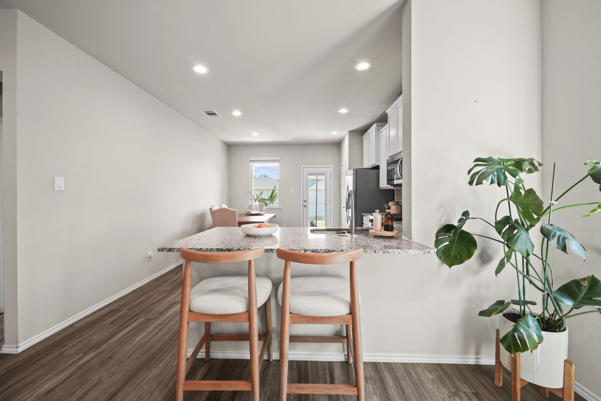Generous kitchen counter space offers plenty of room for meal prep, casual dining, and gathering with family and friends.