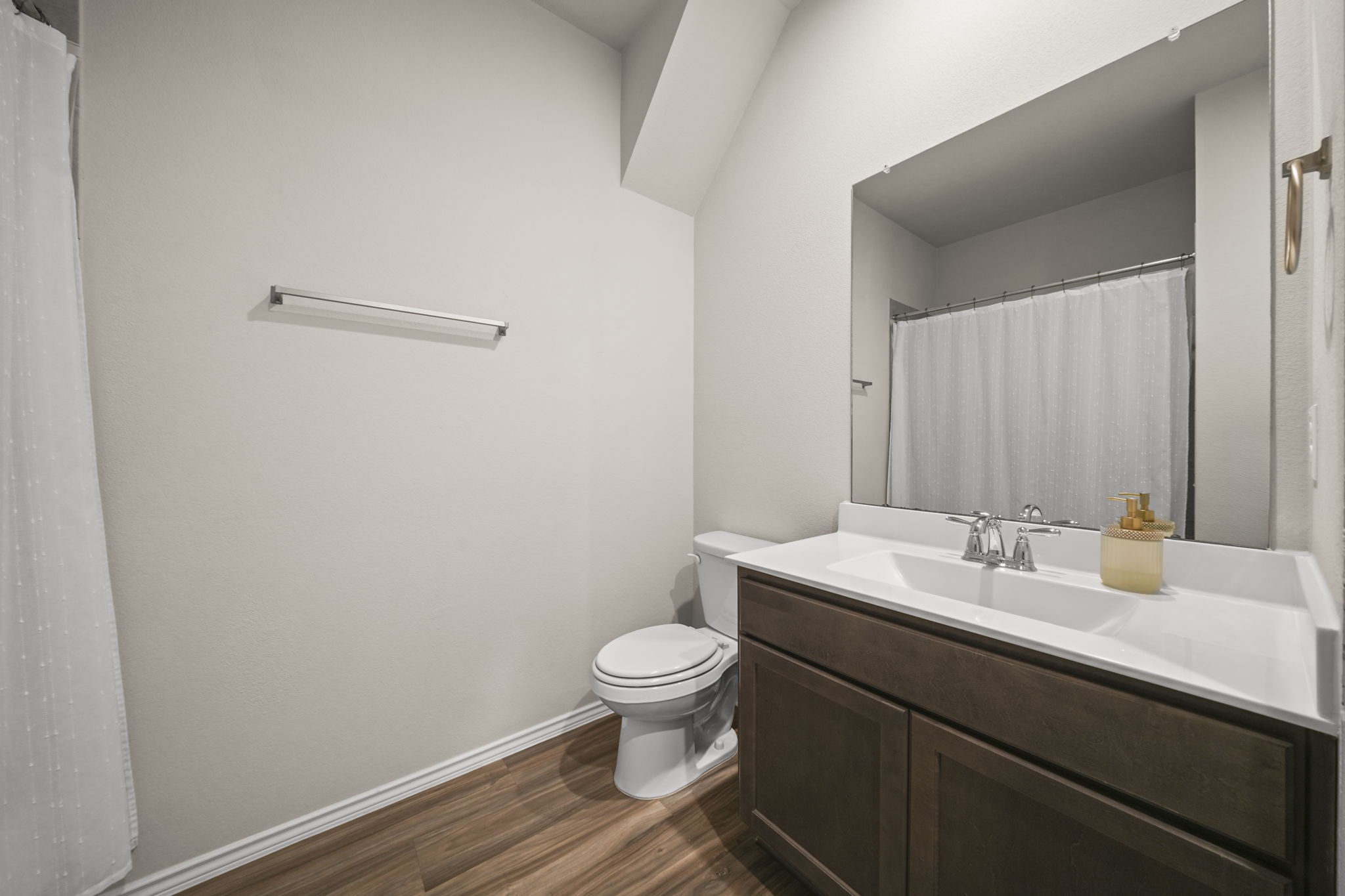 Conveniently located second bathroom with a clean, functional design, perfect for family and guests.