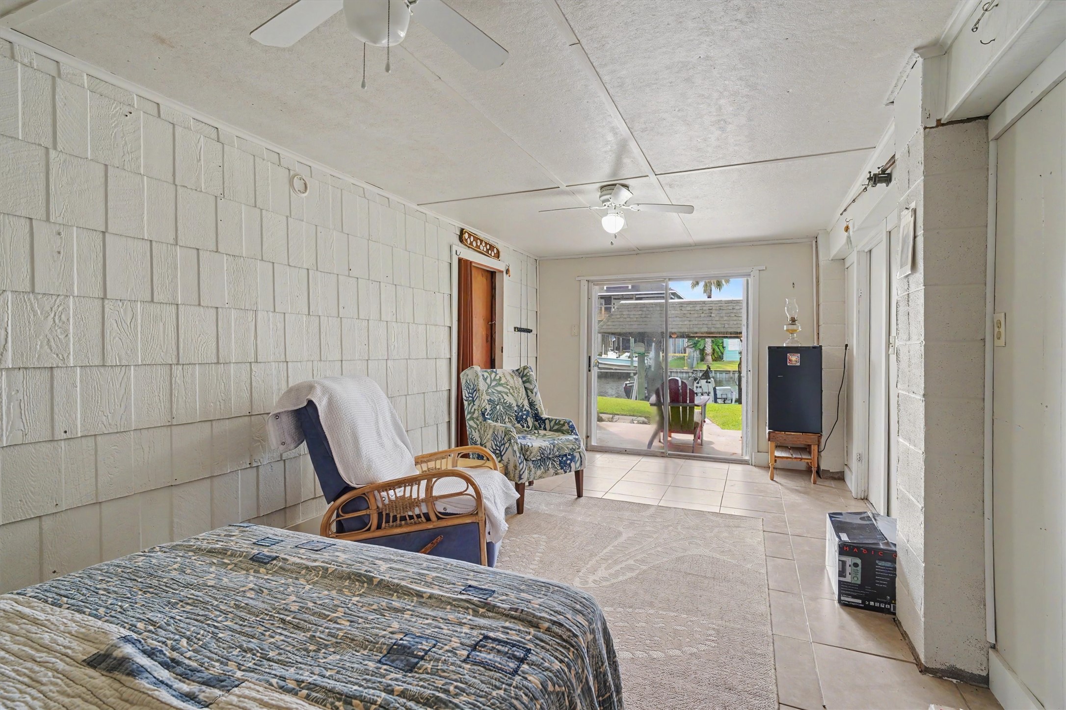 A versatile downstairs space with a sliding glass door and waterfront viewsperfect for an office, guest room, game room, or whatever your lifestyle needs