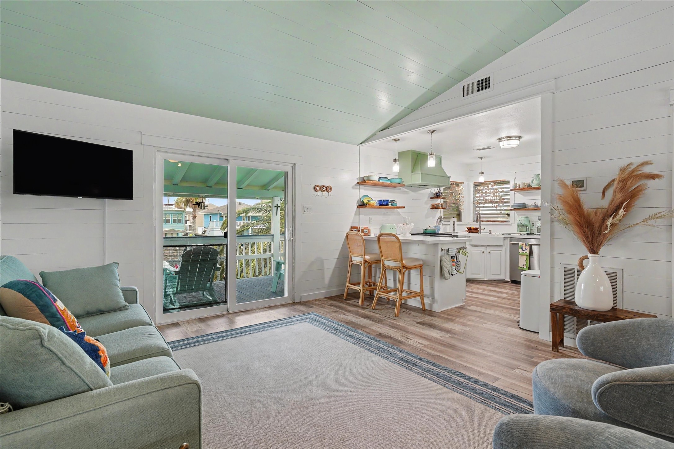 Beautiful LVP flooring, an open-concept design, and painted ceiling, create the perfect blend of relaxed coastal living and modern elegance