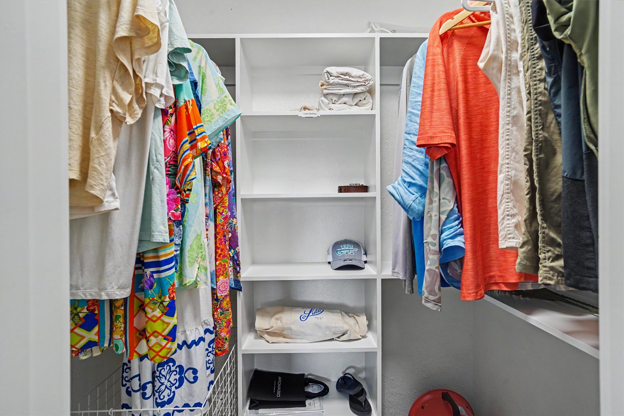 The spacious walk-in primary closet features a thoughtfully designed storage system that maximizes every inch, providing plenty of room to organize clothing, shoes, accessories, and more