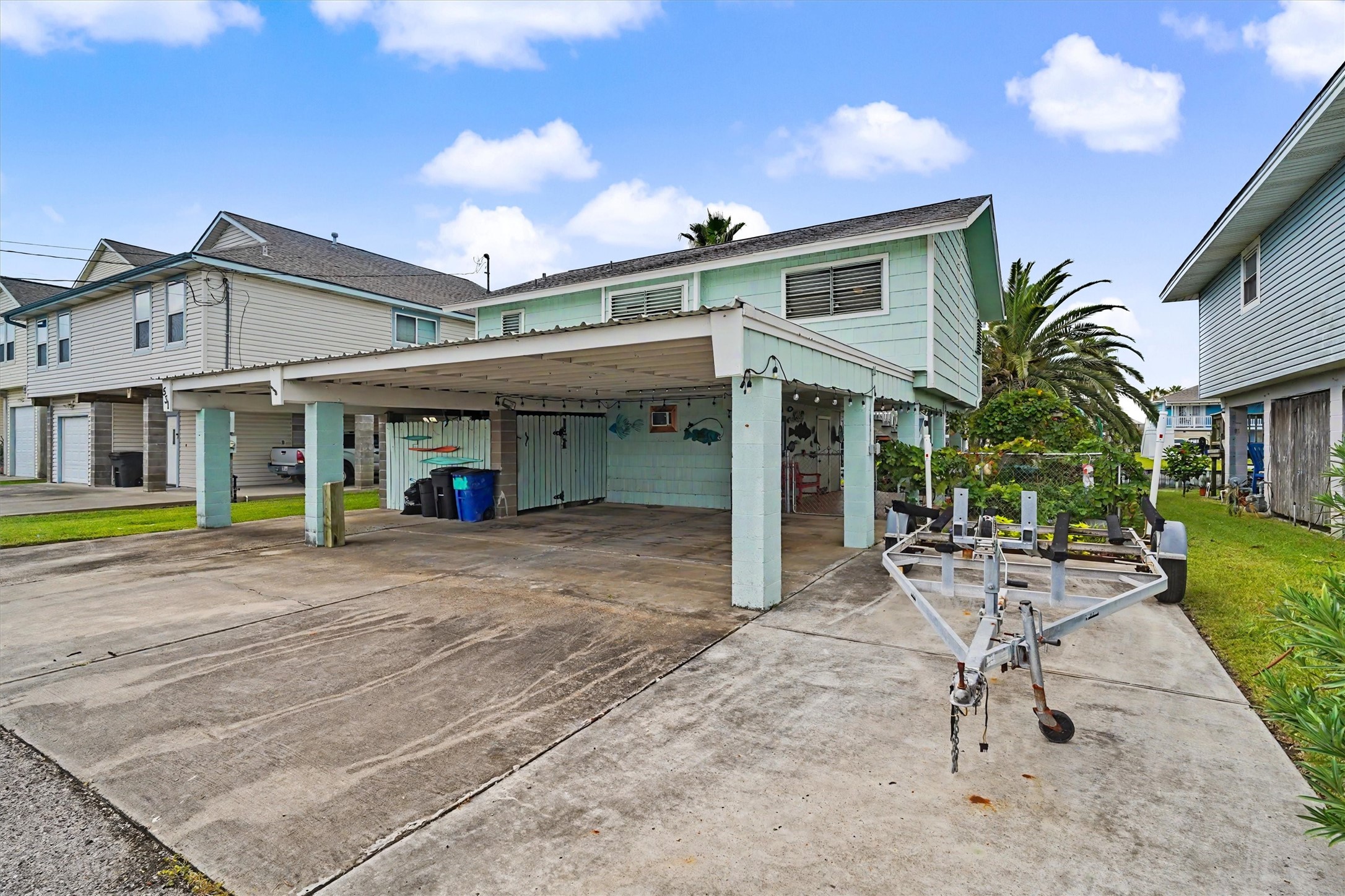 The street side of the home offers plenty of parking, a convenient carport for covered vehicle protection, and additional storage space for all your waterfront gear, tools, and toys. Practical features that make everyday living a breeze!