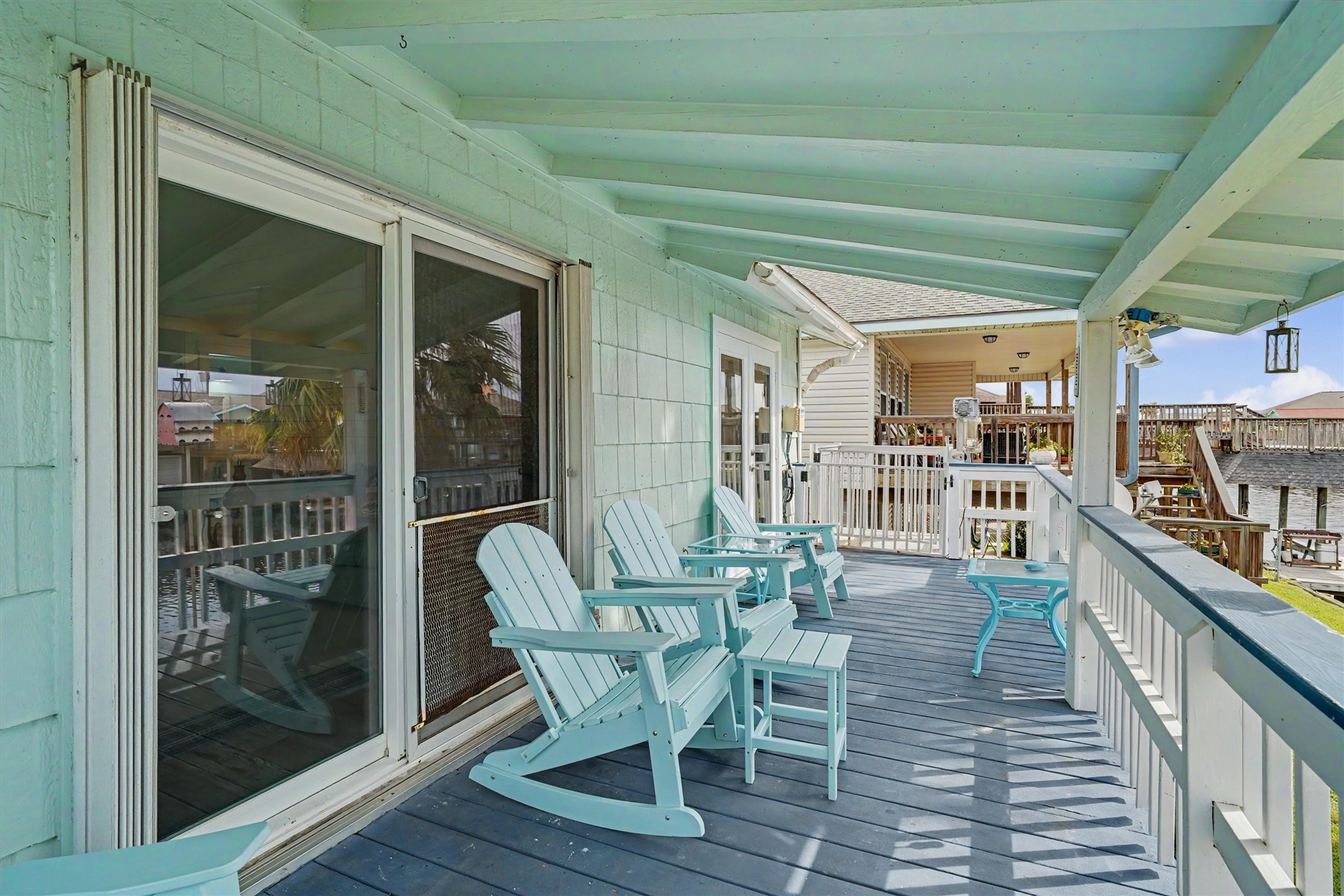 Enjoy the covered upstairs porch with recently installed French doors, creating an inviting connection between indoor and outdoor living. Another set of French doors opens directly into the primary bedroom, bringing the waterfront lifestyle right to your doorstep. Plus, the cargo lift makes transporting groceries, coolers, and everything else from downstairs a breeze! Enjoy the covered upstairs porch with recently installed French doors, creating an inviting connection between indoor and outdoor living. Another set of French doors opens directly into the primary bedroom, bringing the waterfront lifestyle right to your doorstep. Plus, the cargo lift makes transporting groceries, coolers, and everything else from downstairs a breeze!