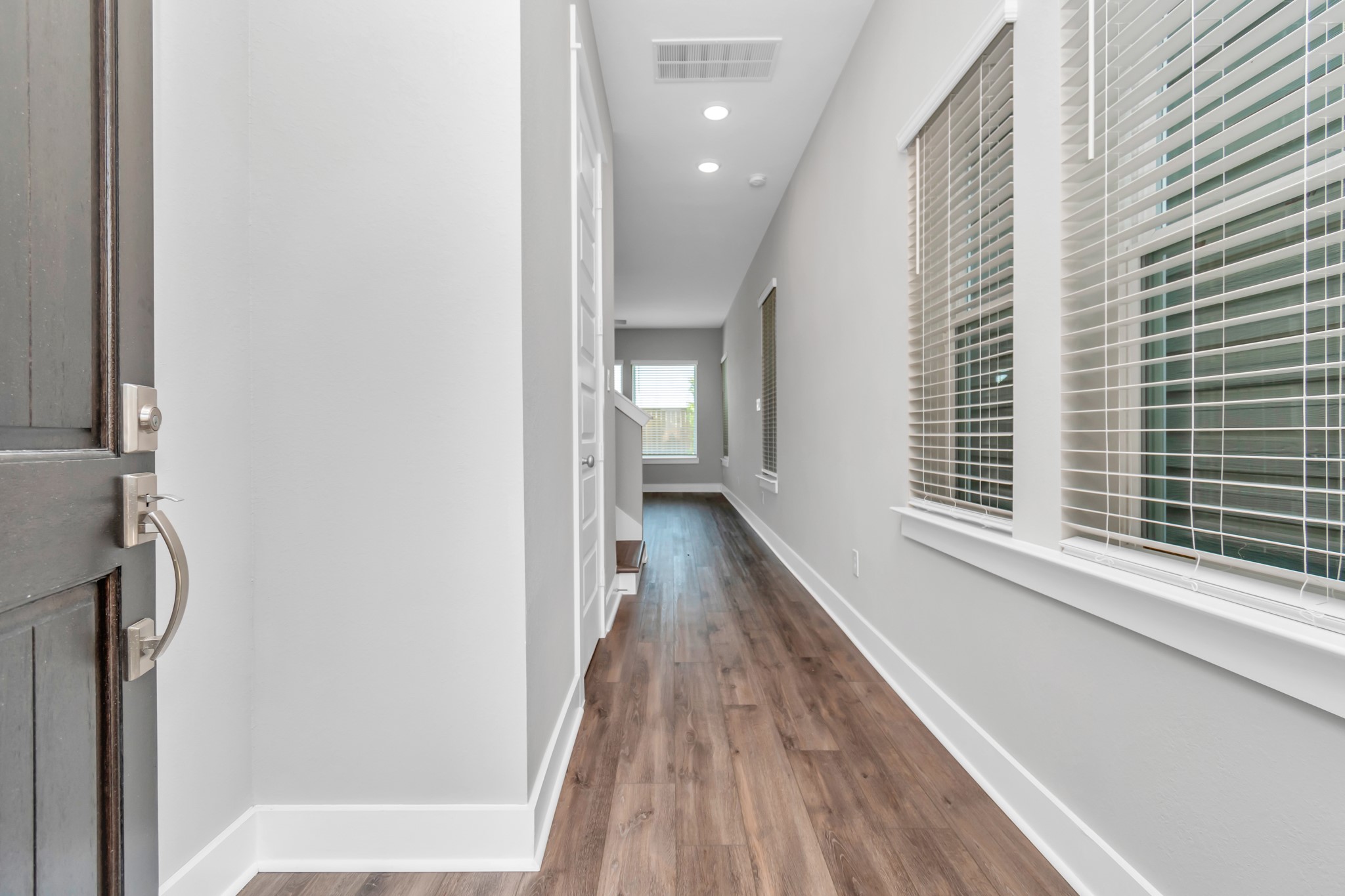 Breathtaking Wood-Like Vinyl Plank Flooring in Entry Way.