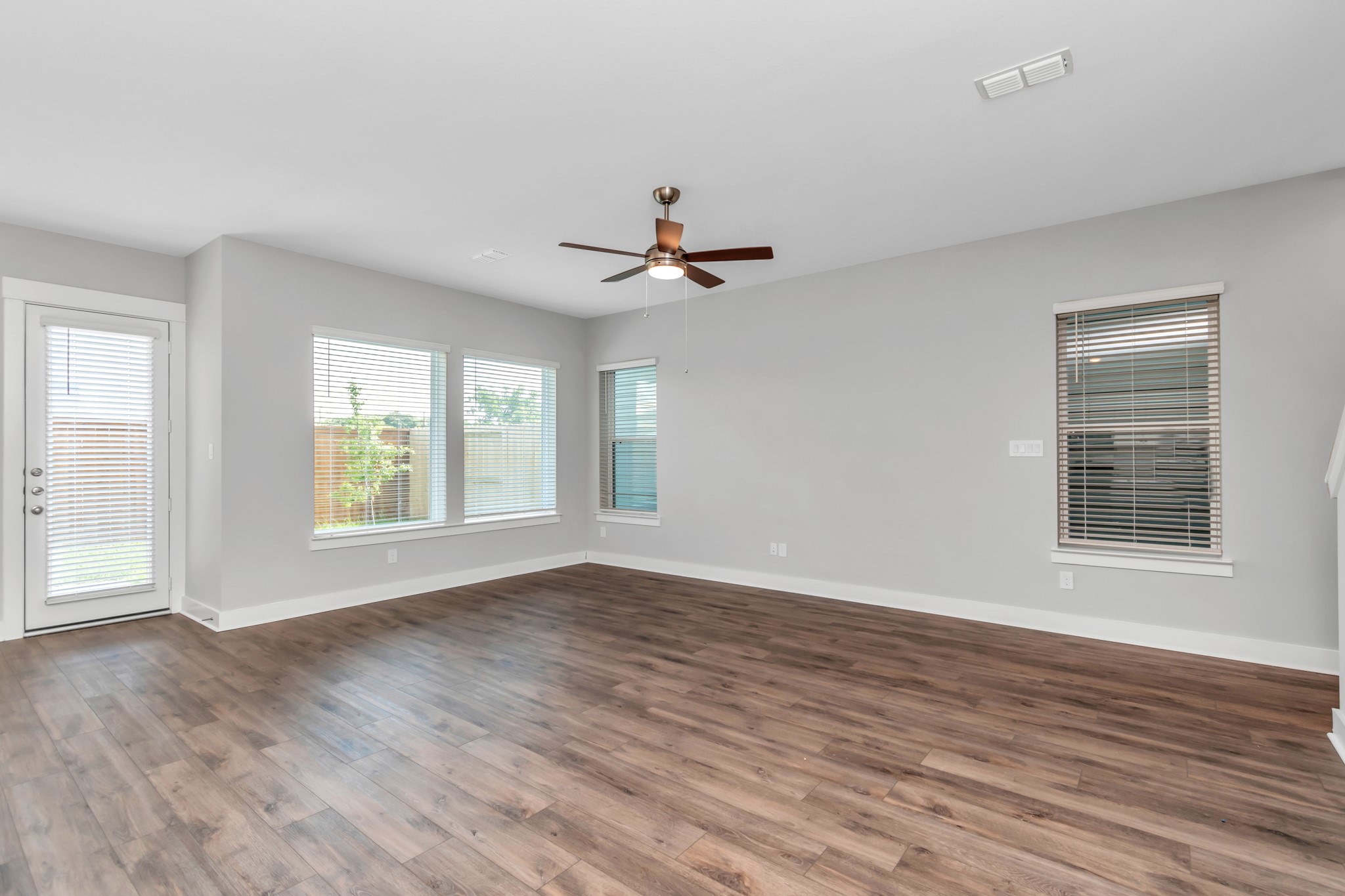 Light & Bright Living Area with Luxurious Wood-Like Vinyl Plank Flooring.
