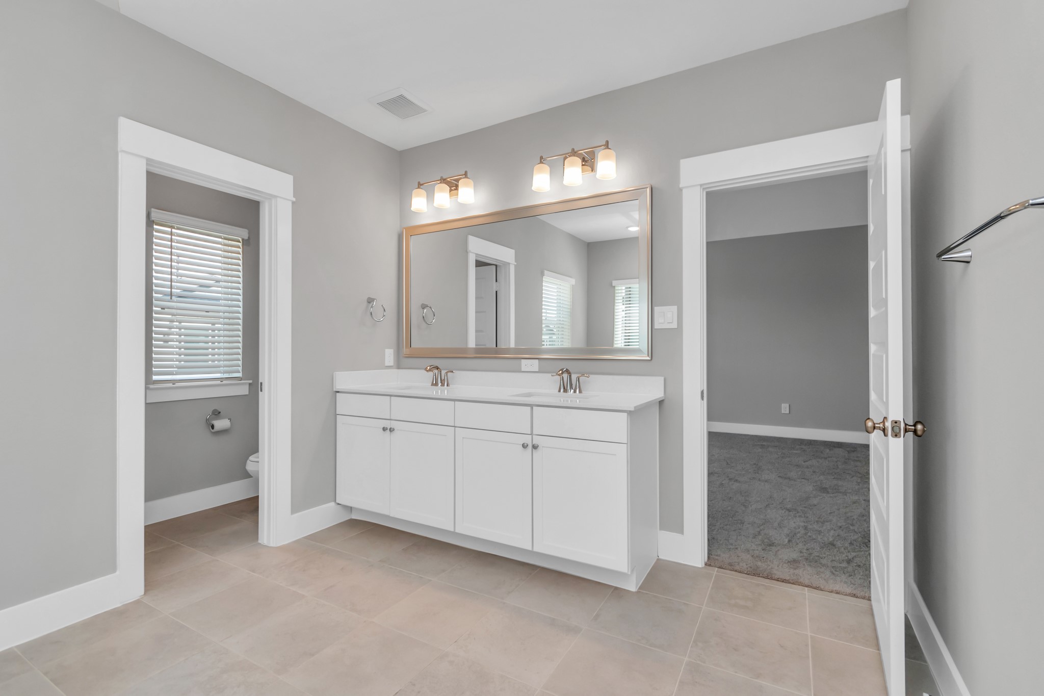 Spa-Like Bath with Spacious Walk-In Shower, Soaking Tub, & Double Sinks with Luxurious Quartz Countertops.