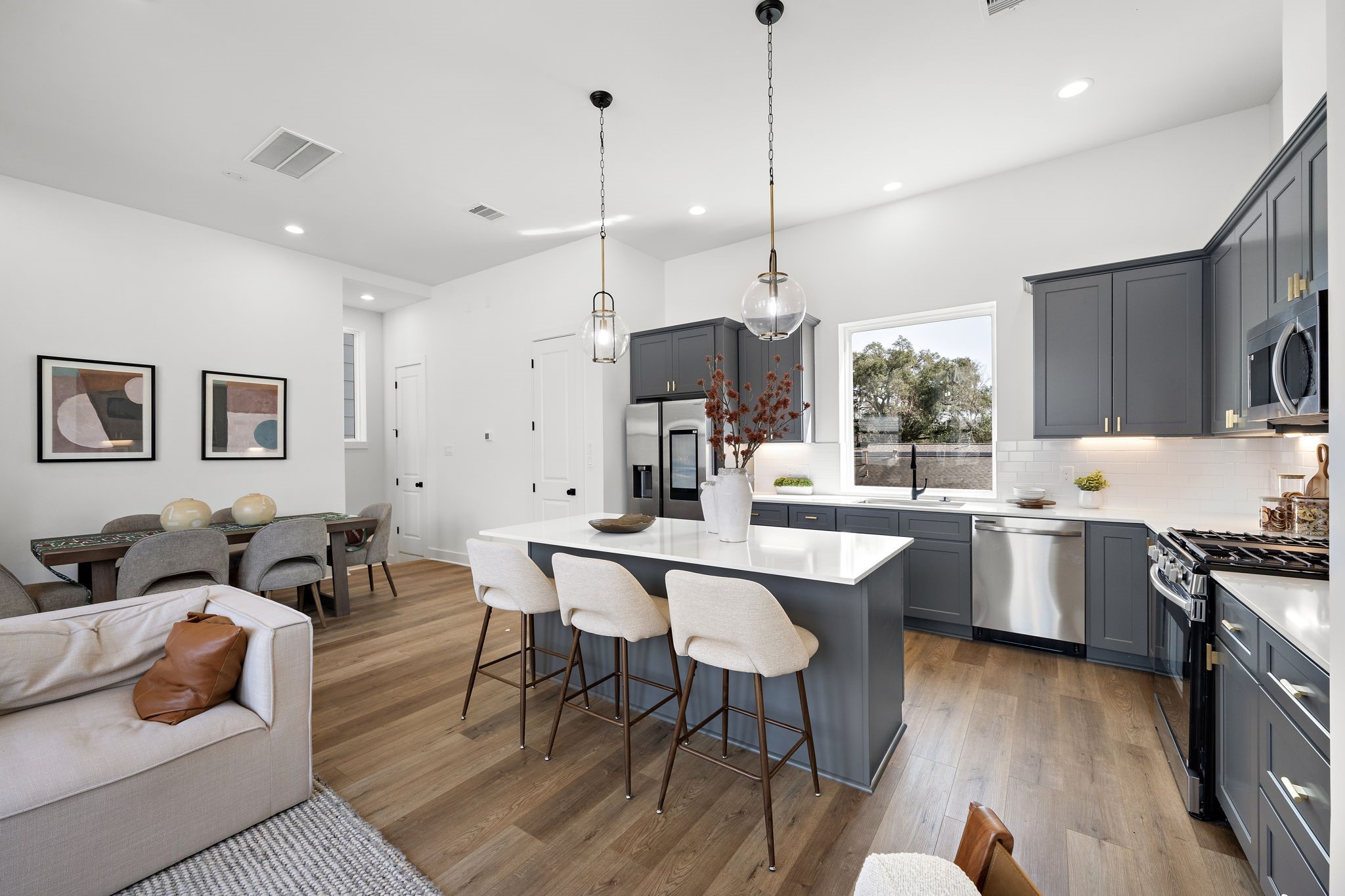 Experience seamless living with this open-concept kitchen, dining, and living area, perfect for modern living and entertaining.