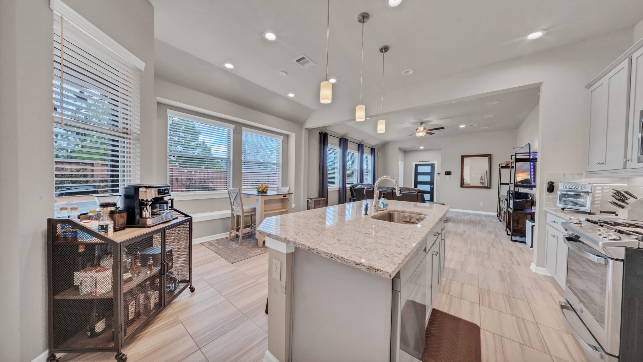 Oversized island with seating, pendant lighting, and generous cabinetry for maximum functionality.