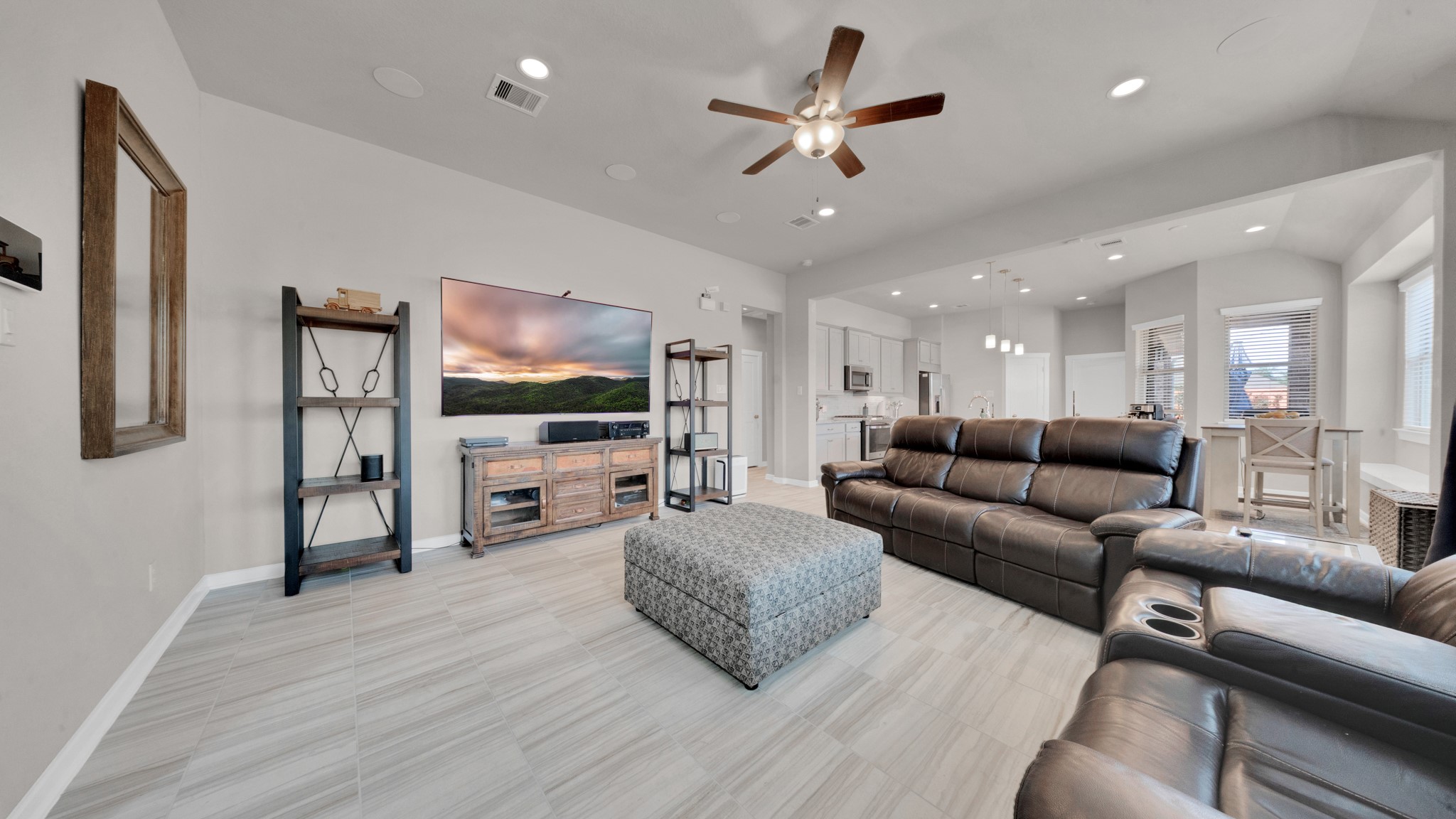 Generous living space featuring large windows, neutral tones, and upgraded tile flooring. Generous living space featuring large windows, neutral tones, and upgraded tile flooring.