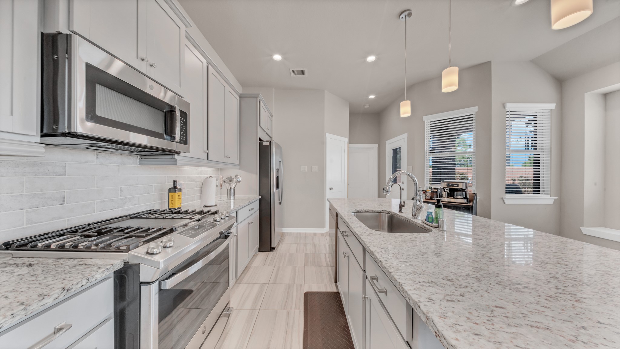 Expansive island and open layout provide perfect connectivity to dining and living spaces.