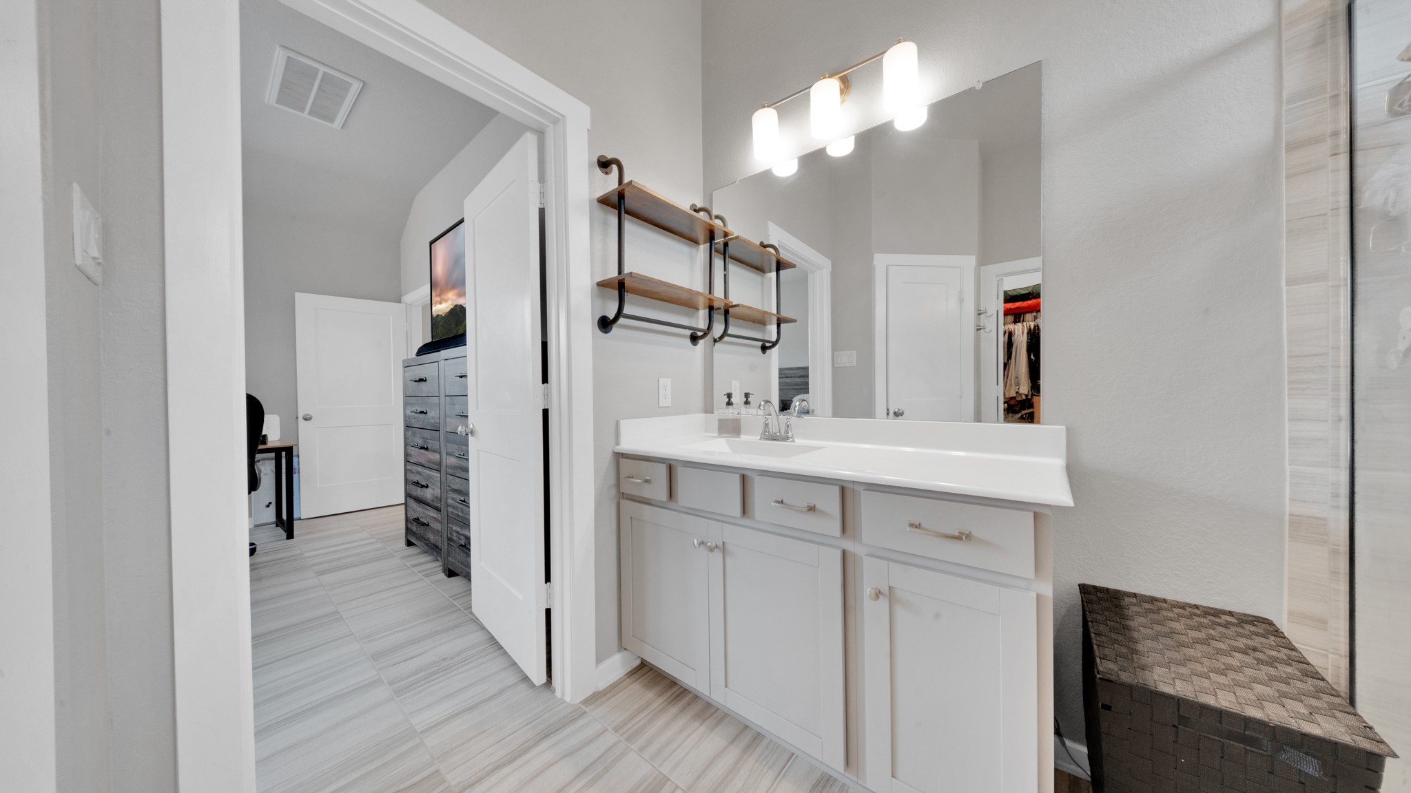 Spacious primary bath featuring dual vanities and an oversized walk-in shower with upgraded tile.