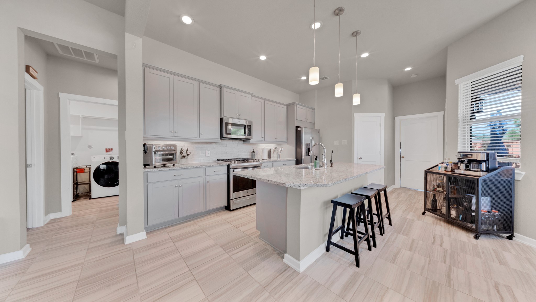 Spacious kitchen with granite countertops, gas cooking, and abundant cabinet storage. Spacious kitchen with granite countertops, gas cooking, and abundant cabinet storage.
