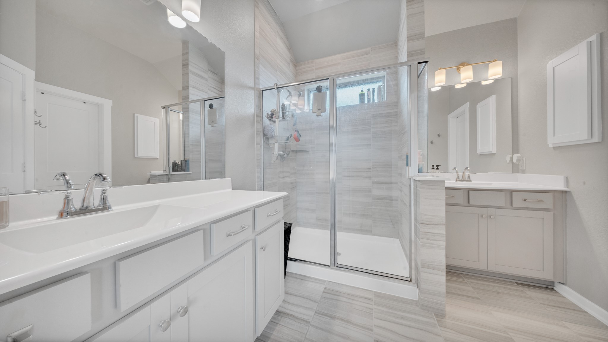Dual sink vanity with ample storage and contemporary fixtures.
