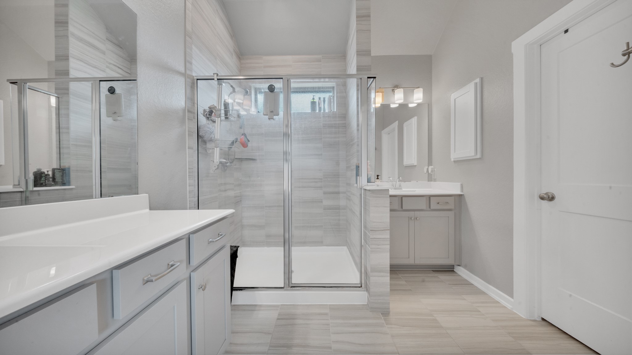Beautifully designed bathroom offering two separate vanities and a bright, open layout.