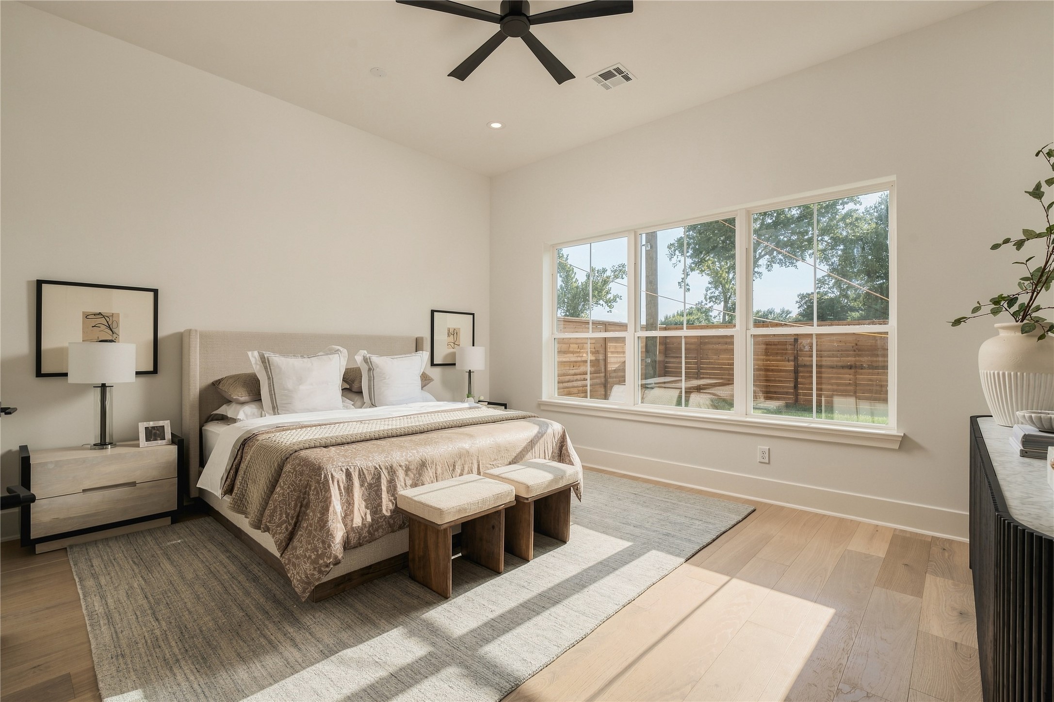 The primary suite offers impressive scale and abundant natural light, creating a serene retreat with ample room for a dedicated sitting area.