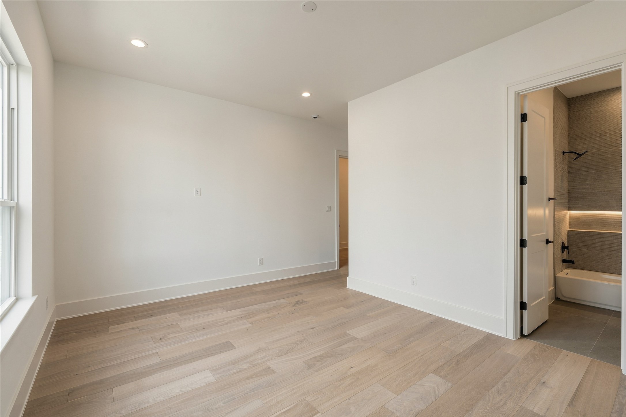 A second perspective reveals the bedrooms walk-in closet and generous floor space, allowing for multiple furniture configurations without compromising the rooms openness.