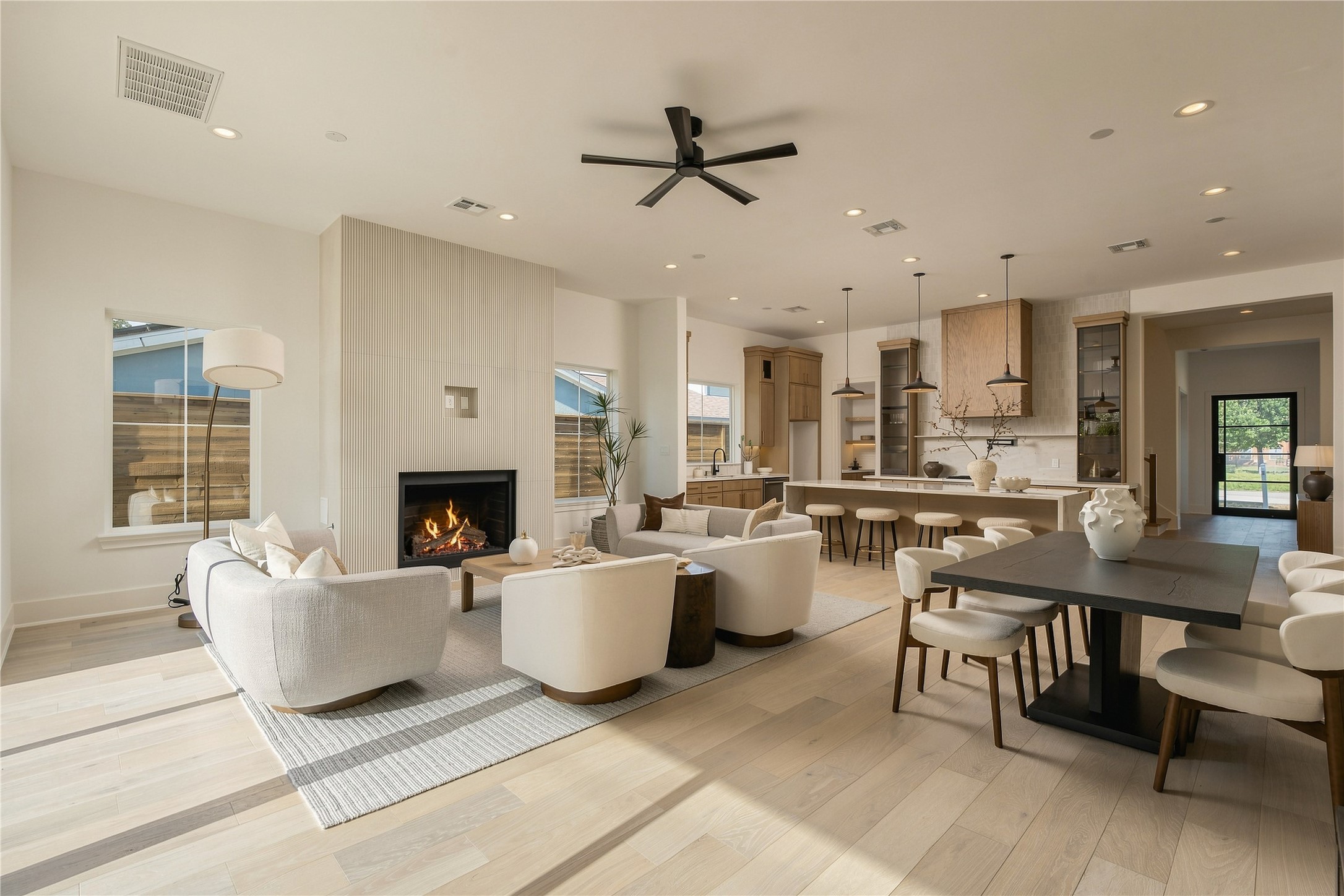 From this perspective, the homes open-concept design comes fully into view, connecting the living, dining, and kitchen areas into one expansive setting designed for everyday life and larger gatherings alike.