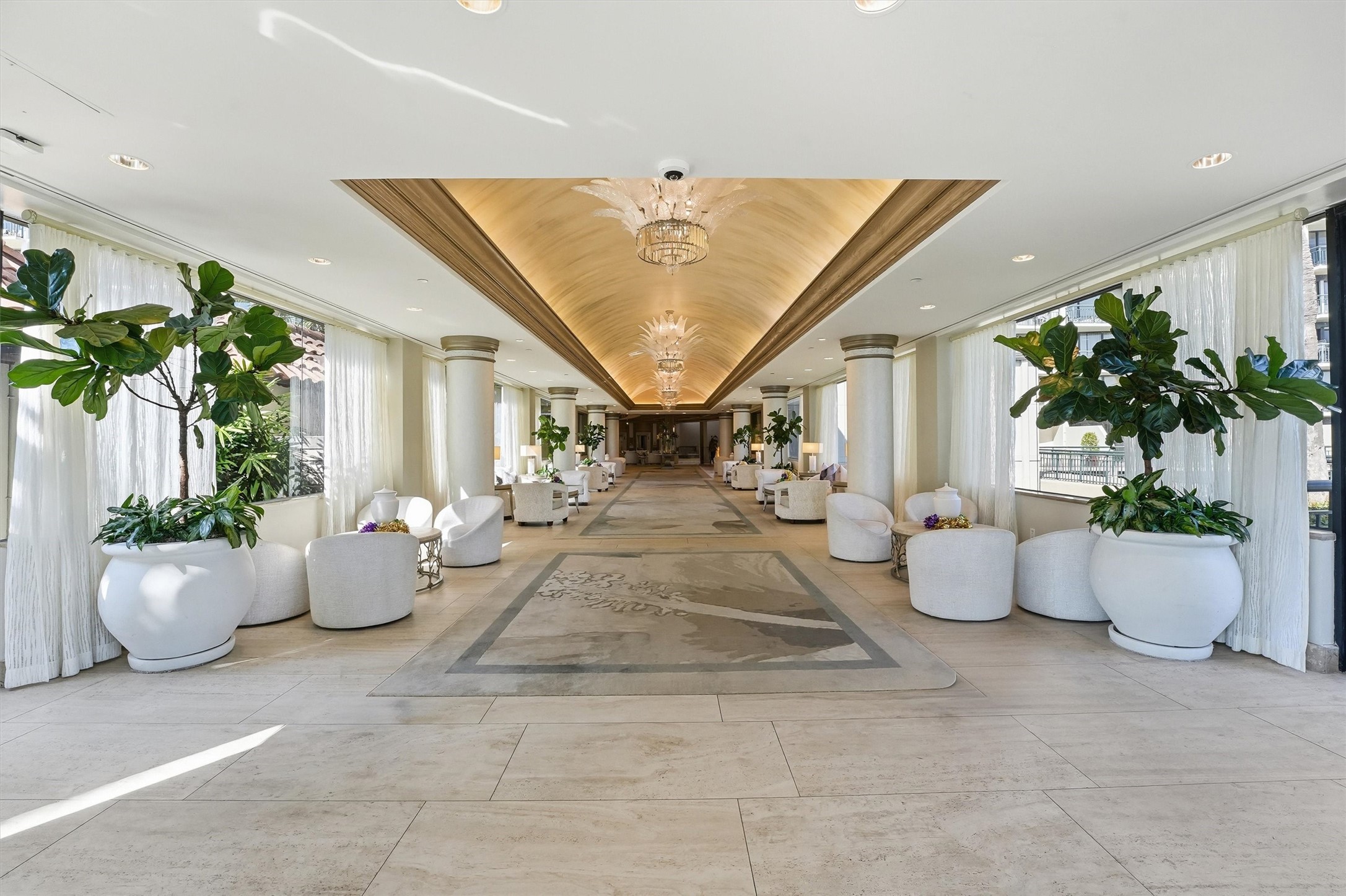 The grand lobby welcomes residents and guests with elegant finishes, attentive concierge service, and a refined coastal ambiance.