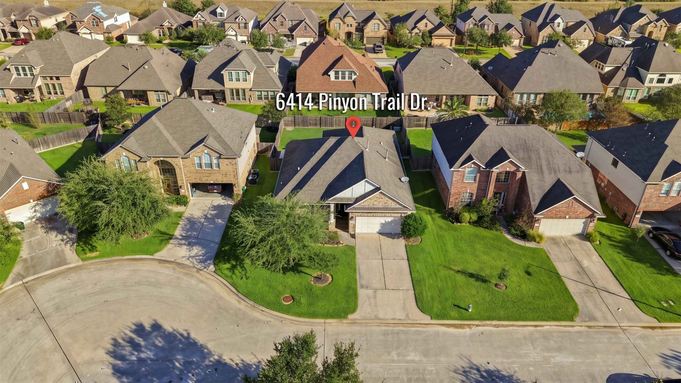 Enjoy this suburban home with a neatly manicured lawn, spacious driveway, and appealing brick facade, nestled in a well-maintained neighborhood.