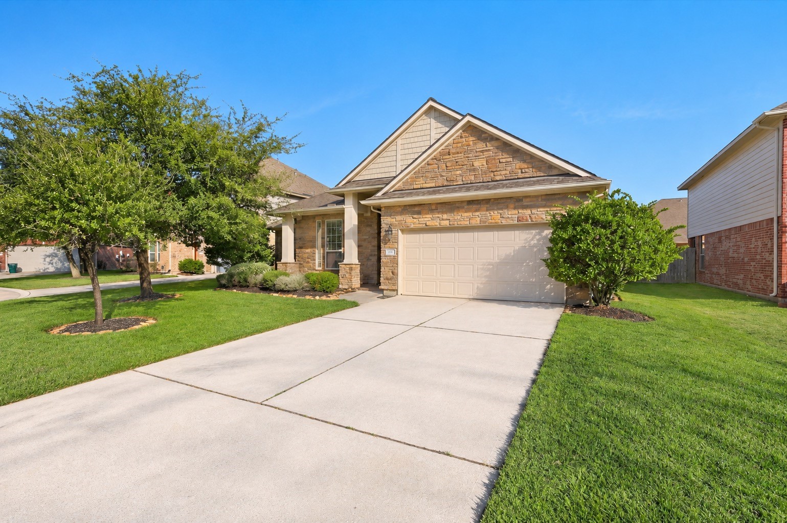 This single-story home with a stone facade, two-car garage, and well-maintained landscaping, is nestled in the master-planned community of Auburn Lakes.