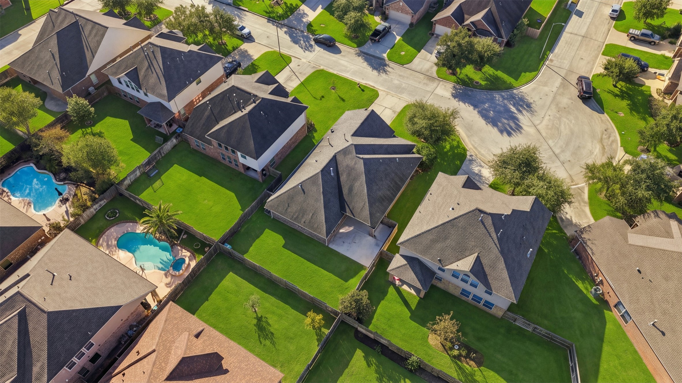 Charming suburban neighborhood with beautifully maintained homes and lush green lawns, featuring inviting backyard pools perfect for relaxation and entertainment.