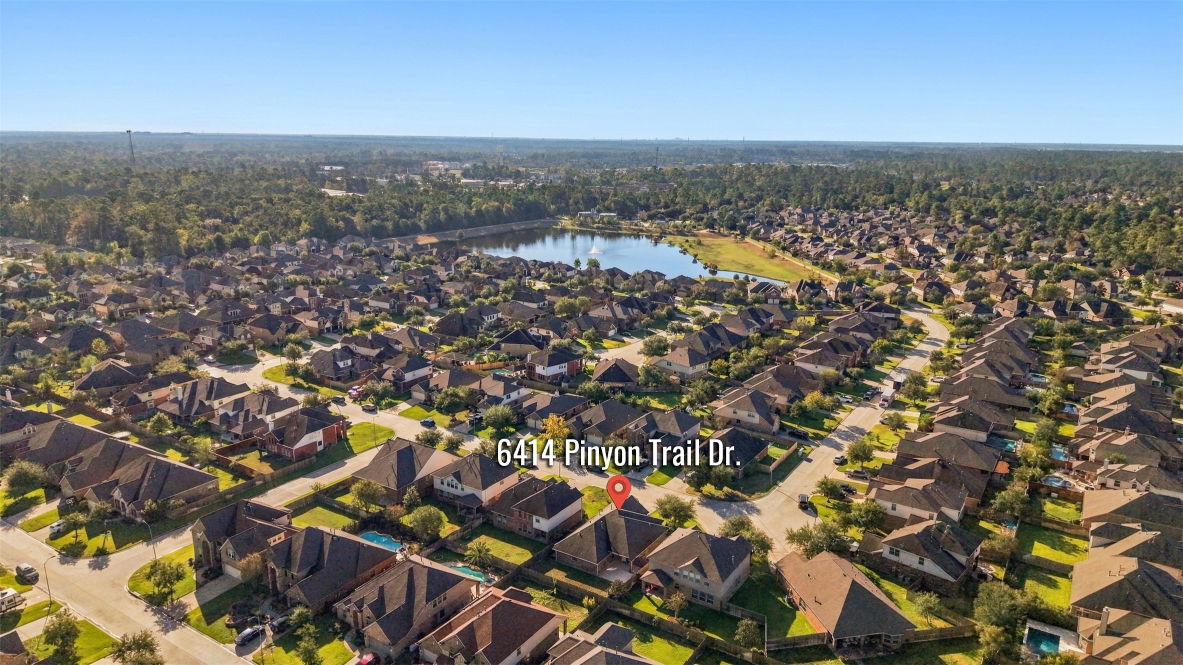 The neighborhood with a serene lake view, nestled among lush greenery and well-maintained homes, offering a peaceful suburban lifestyle.