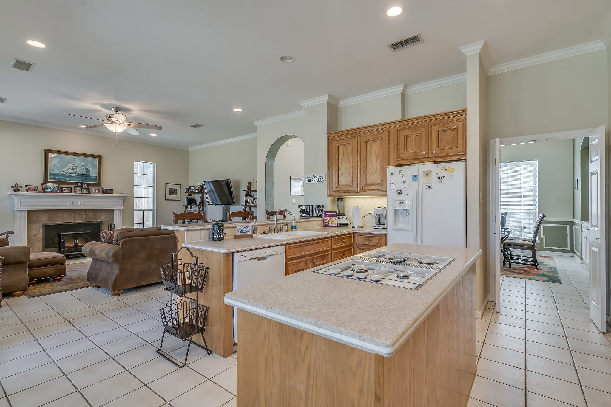 Experience the perfect blend of openness and convenience in this airy space, featuring a seamless backdoor exit ideal for effortless grilling and eating al fresco