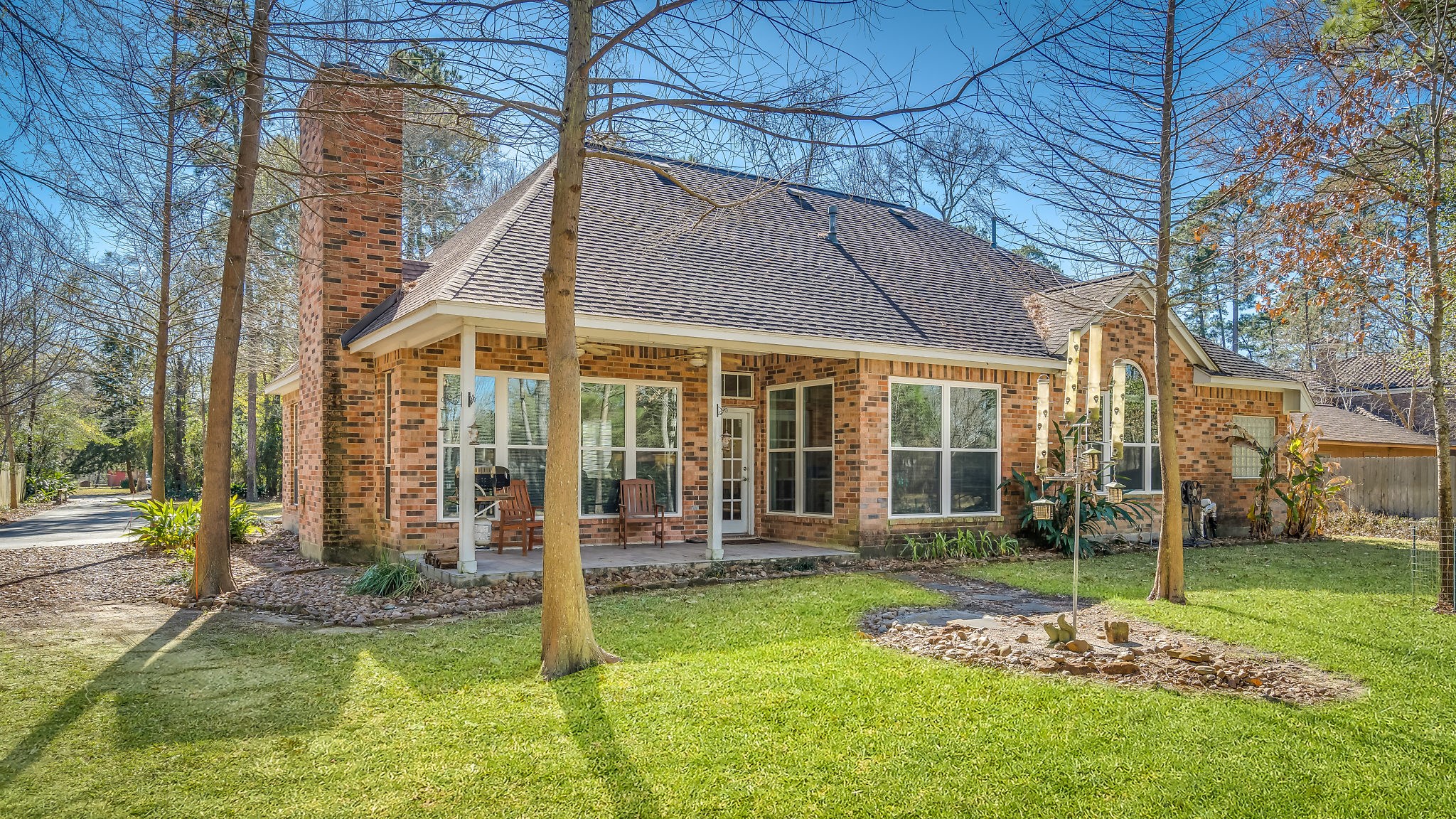 Unwind on the inviting covered patio of this charming brick home, perfect for relaxing evenings surrounded by nature