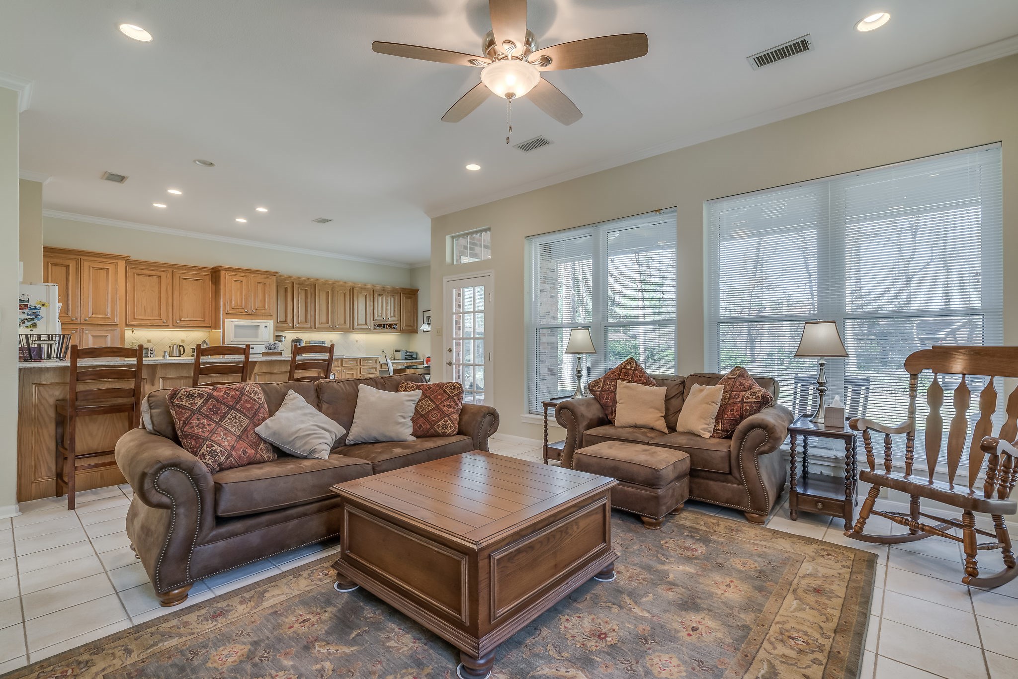 Inviting living space seamlessly blends comfort and style, offering expansive windows that showcase stunning backyard views, perfect for relaxation and entertaining