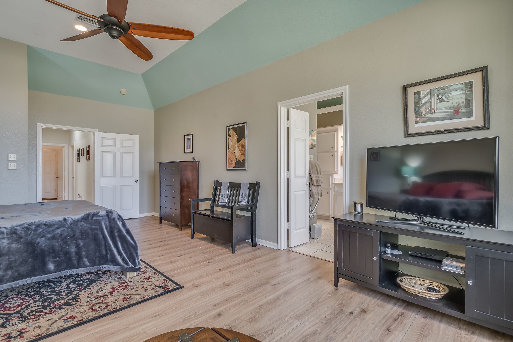 Discover the spacious primary suite featuring stylish laminate flooring, offering a perfect blend of comfort and elegance
