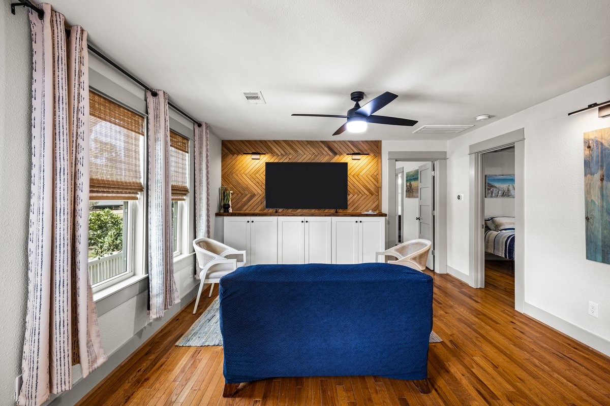 Stunning wood feature wall creates a warm, inviting living room with classic Galveston charm.