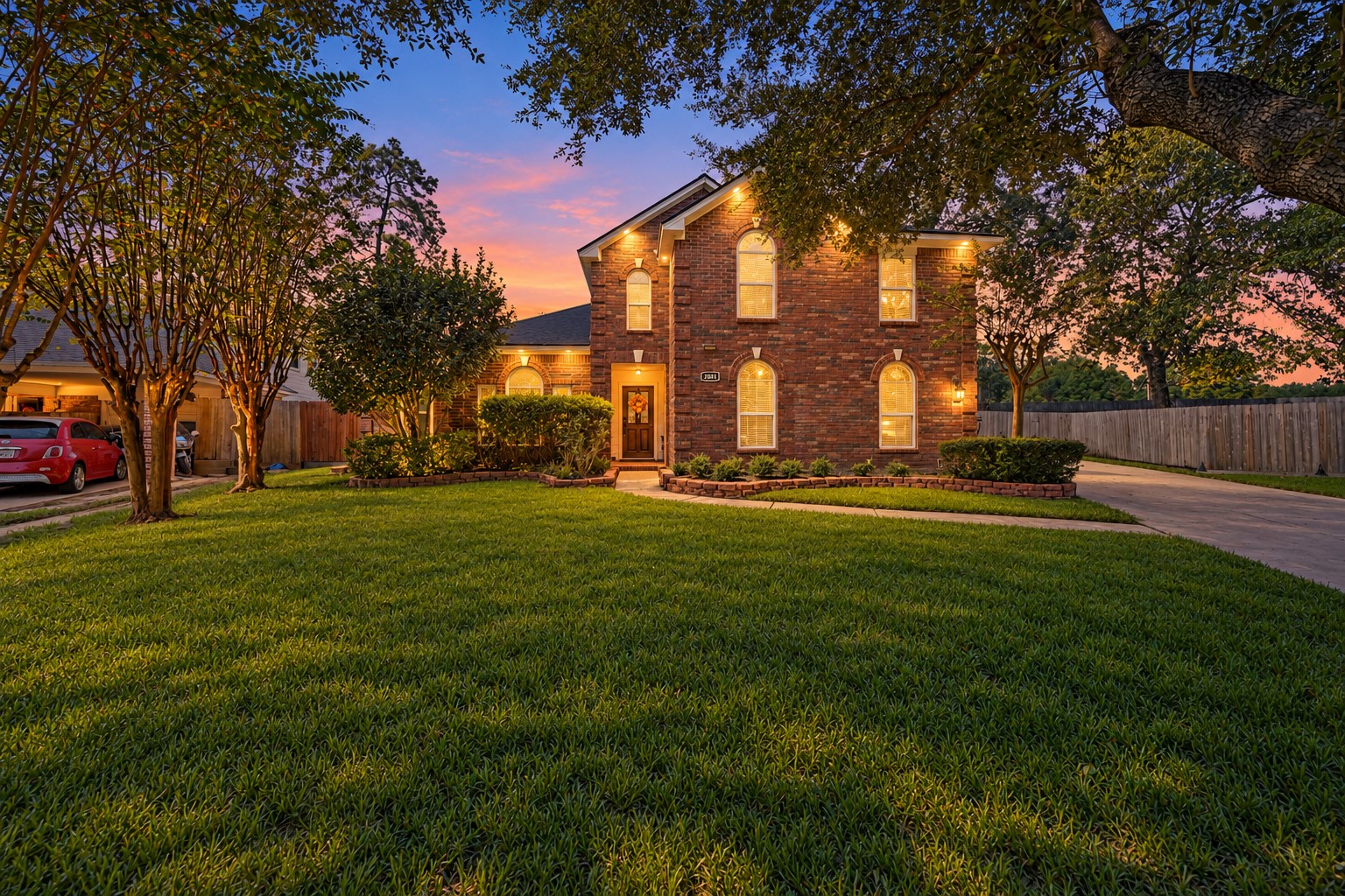 Elegant front exterior beneath sunset skies.