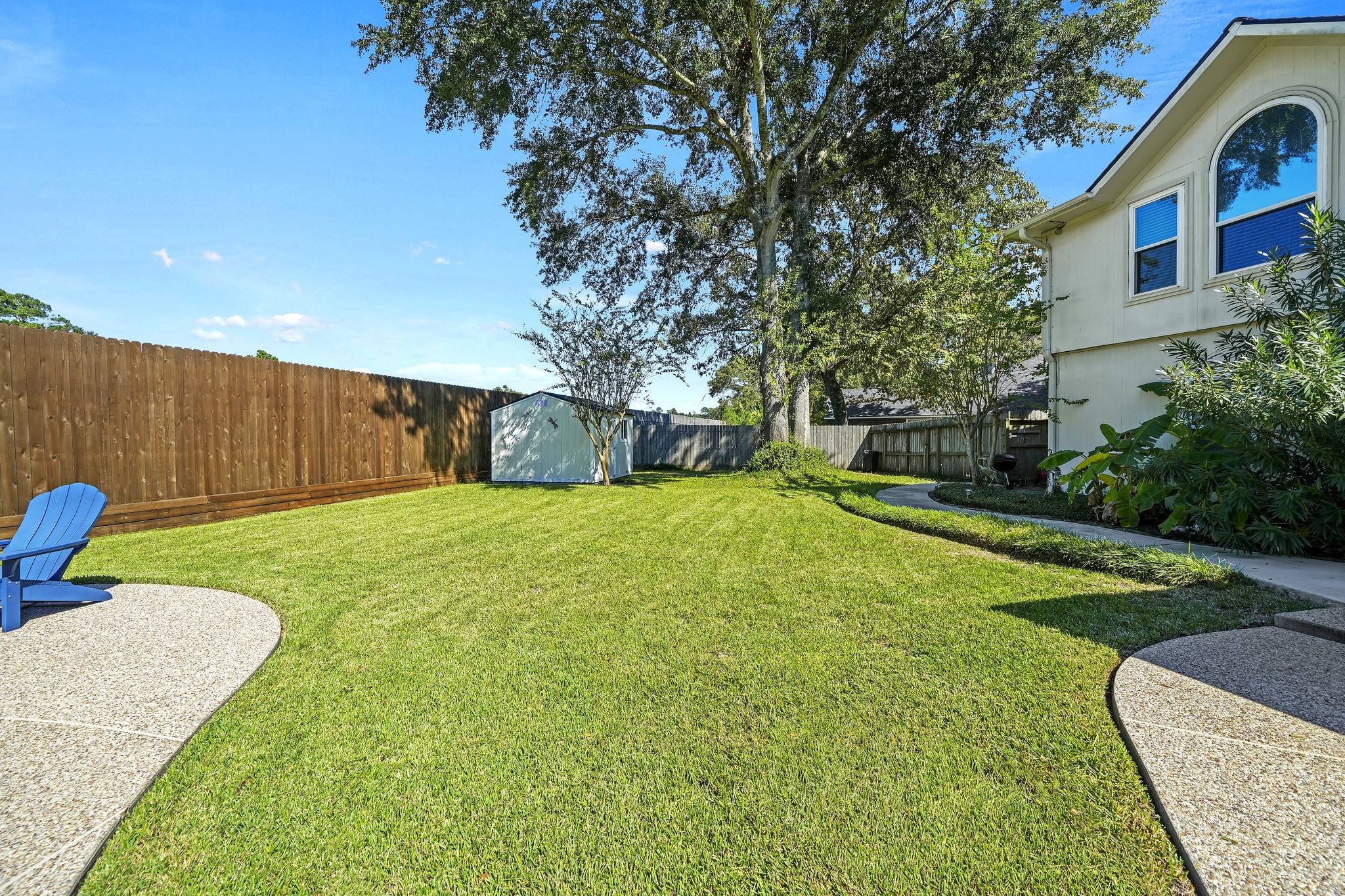 Sprawling backyard with lush lawn.