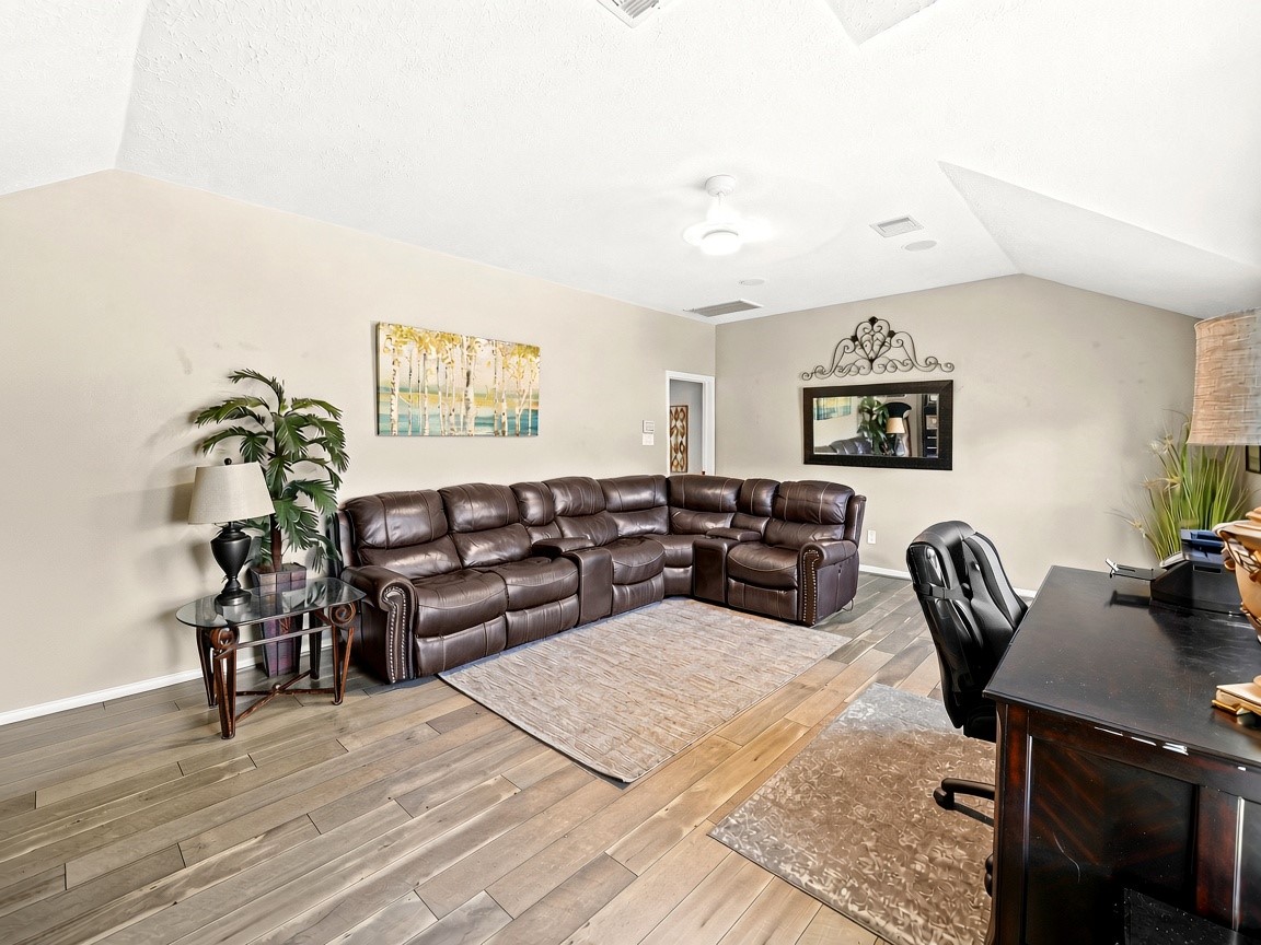 Expansive upstairs game room. Virtually staged.