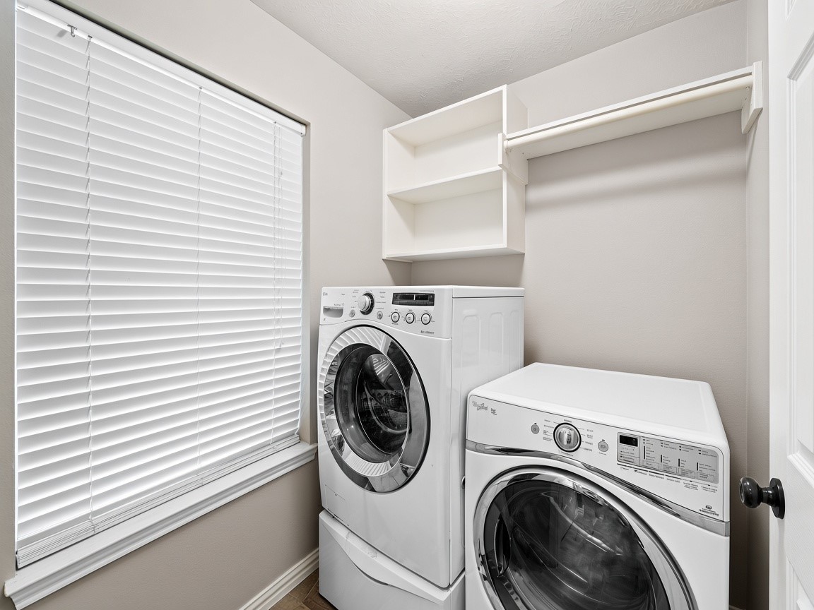 Convenient laundry room with extra storage. Virtually staged.