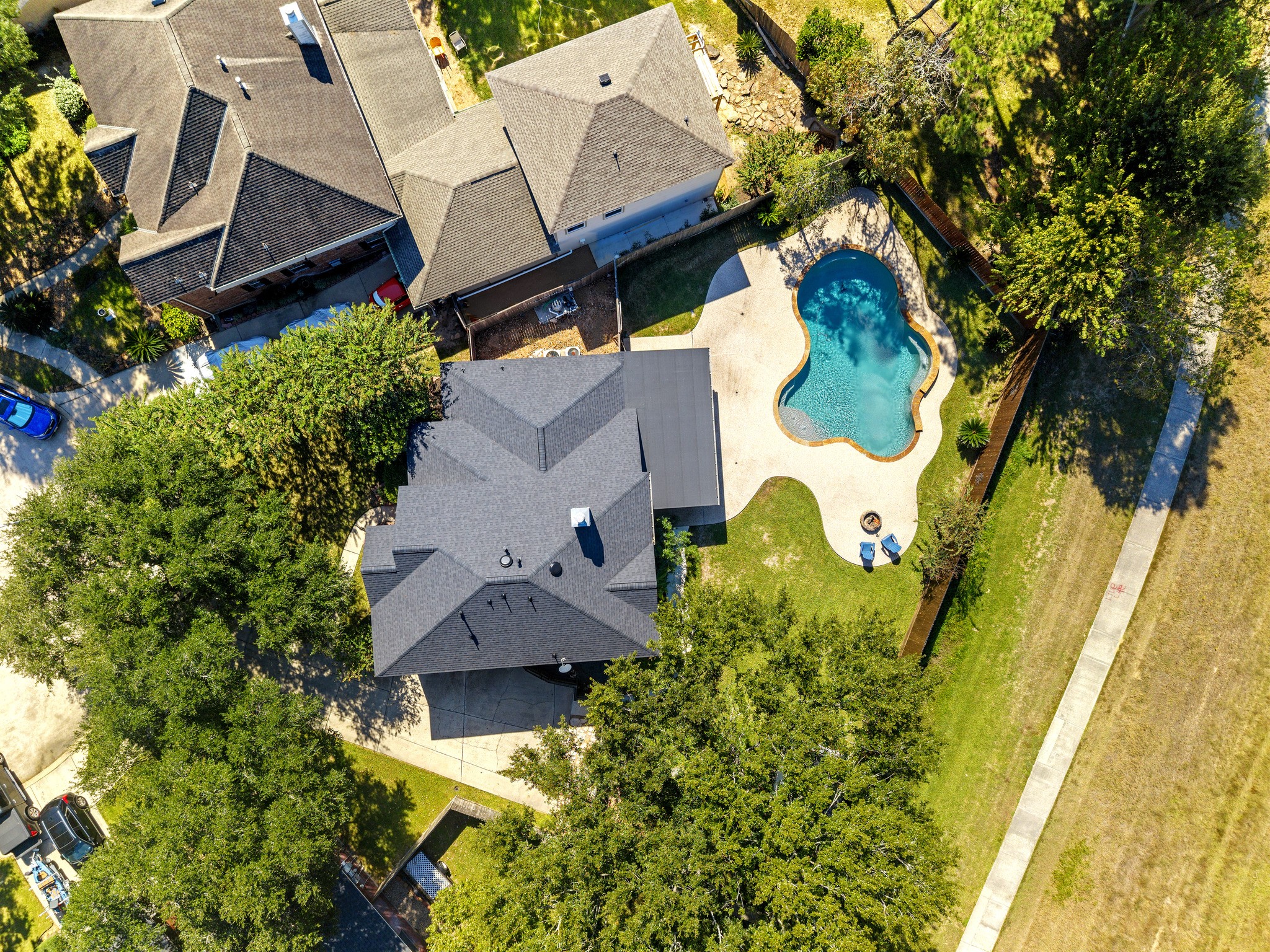 Aerial view of the pool and lot. Virtually staged.