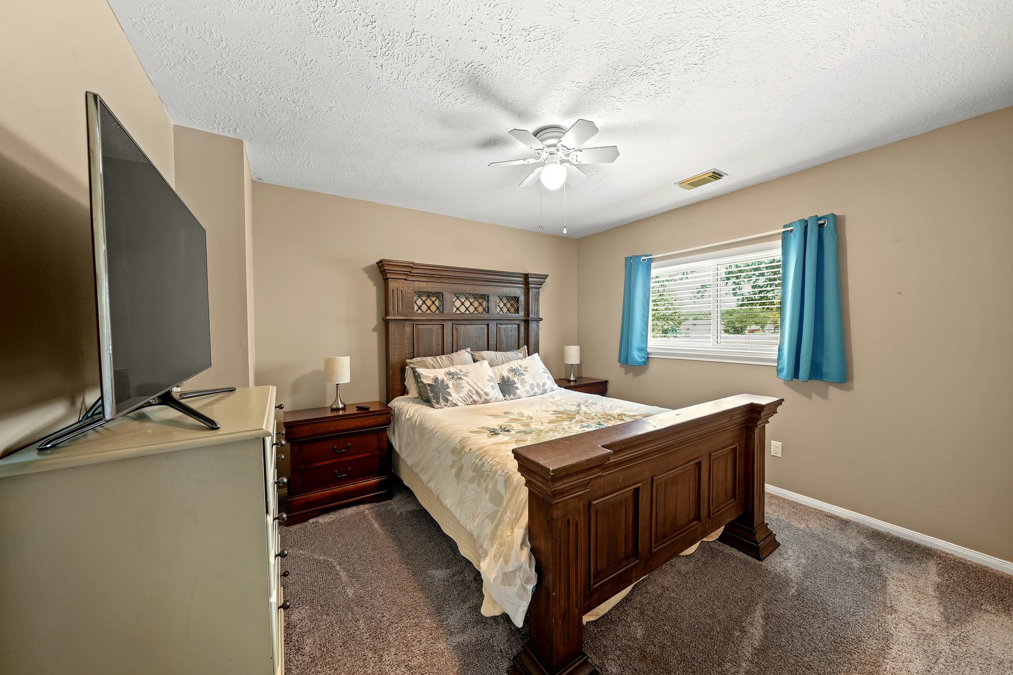 Tranquil bedroom with a sunny window. Virtually staged.