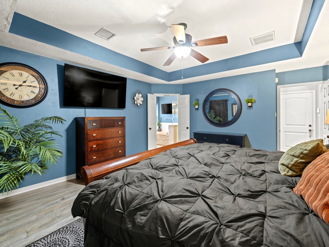 Spacious primary bedroom with natural light.