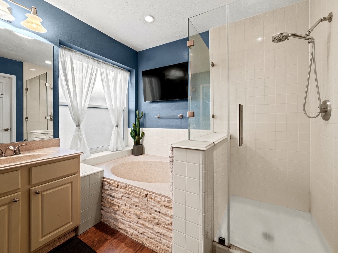 Luxurious primary bath with soaking tub. Virtually staged.