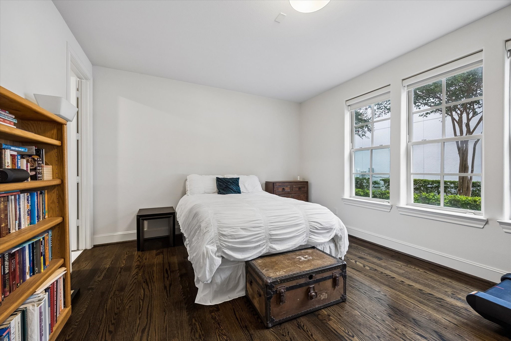 Conveniently located on the first floor, this secondary bedroom offers hardwood floors, generous proportions, and abundant natural light from a wall of windows. Ideal for guests or multigenerational living with added privacy from the upstairs bedrooms.