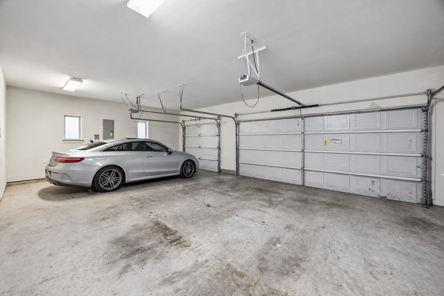 An oversized three car garage provides plenty of room for vehicles, storage, and everyday gear. Direct access from the private rear drive adds convenience while keeping parking tucked away from the homes main entrance.