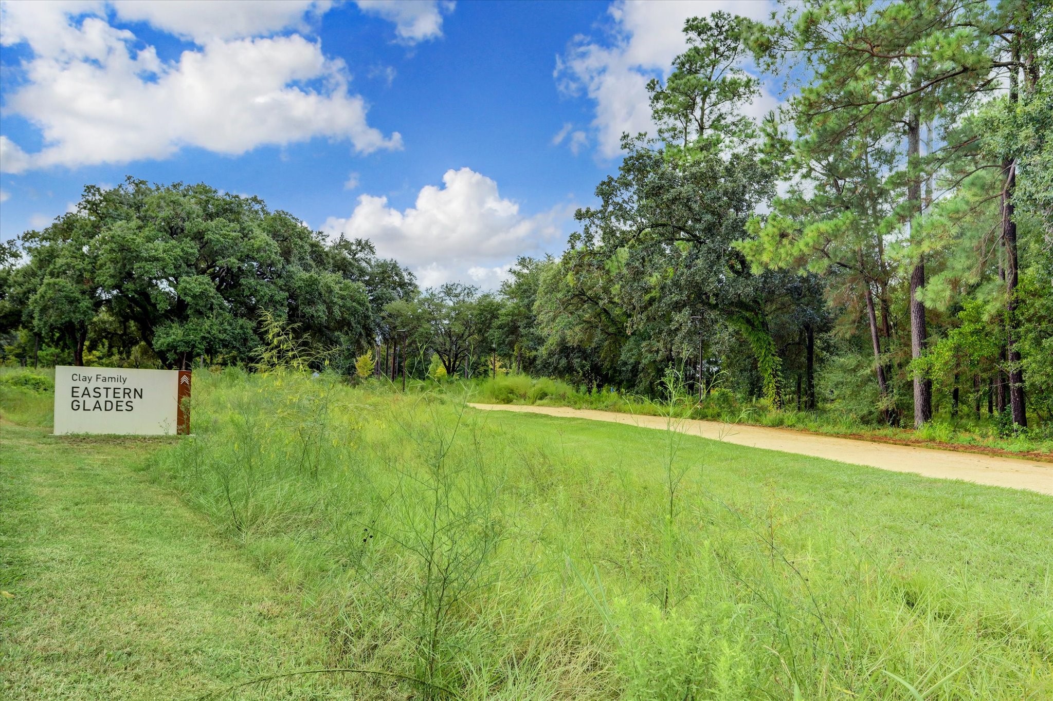 Clay Family Eastern Glades offers miles of natural walking trails, open green space, and preserved woodland just minutes from the home, providing a quiet escape into nature without leaving the city.
