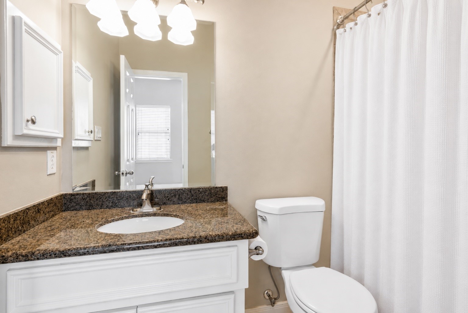 Ensuite bath with granite countertop, tub/shower in rear 3rd level bedroom
