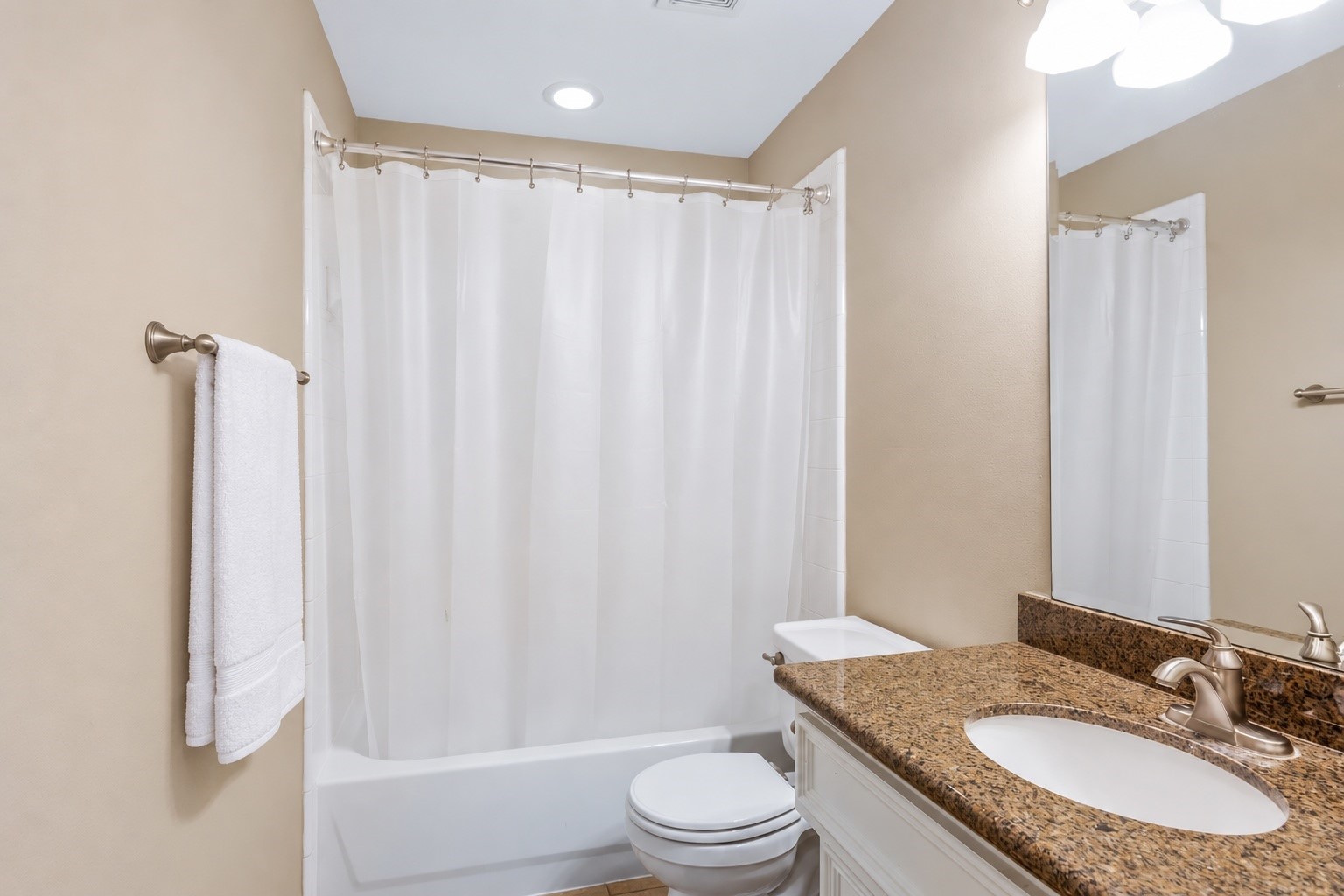 1st level bathroom with tub/shower, granite countertops
